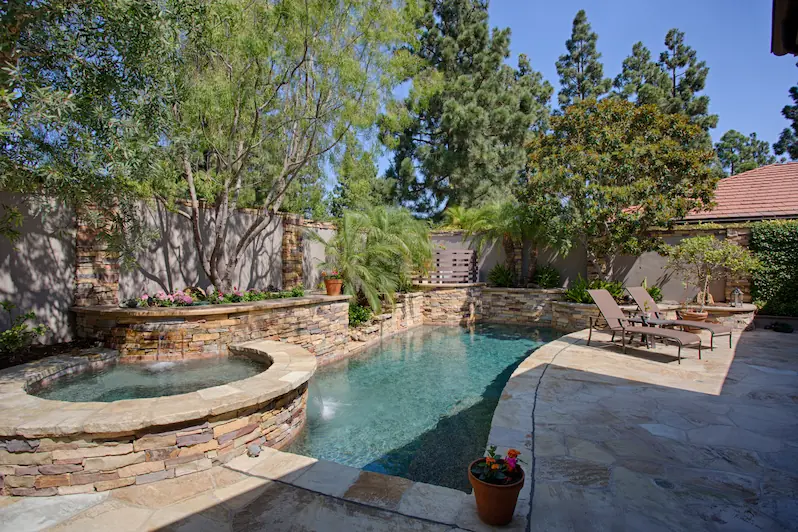 Beautifully landscaped pool and hardscape area from the Big Canyon Remodel project. Photo by Chris Darnall.