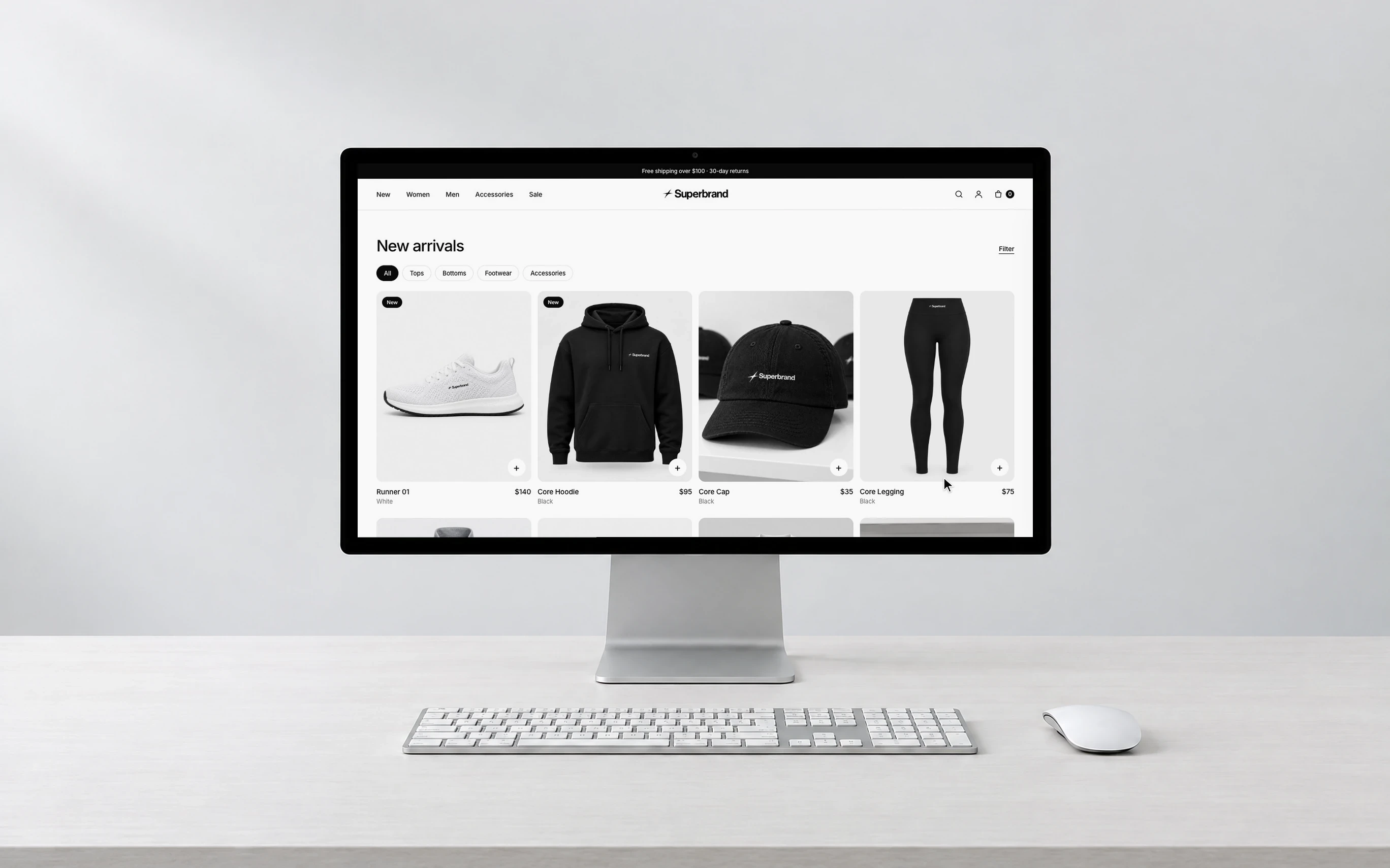 A desktop computer showing Superbrand’s store: new arrivals with trainers, a hoodie, a cap and leggings.