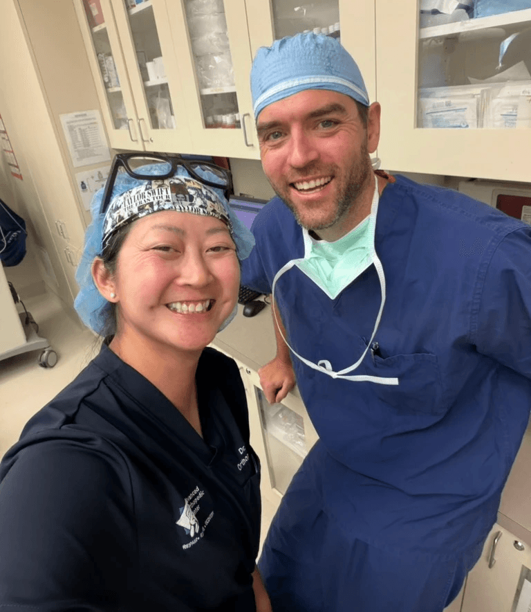 Advanced Orthopedic Center doctors smiling with eachother in an office