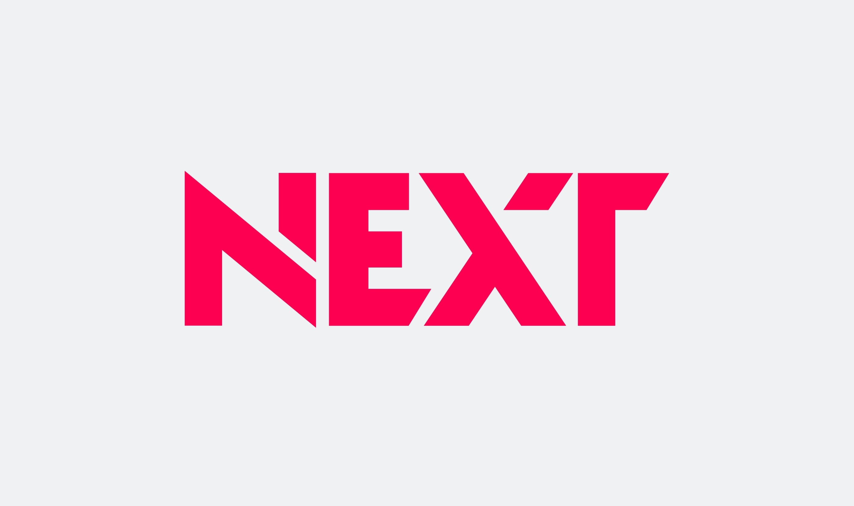 "NEXT" wordmark in bold pink italicised lettering on a light grey background.