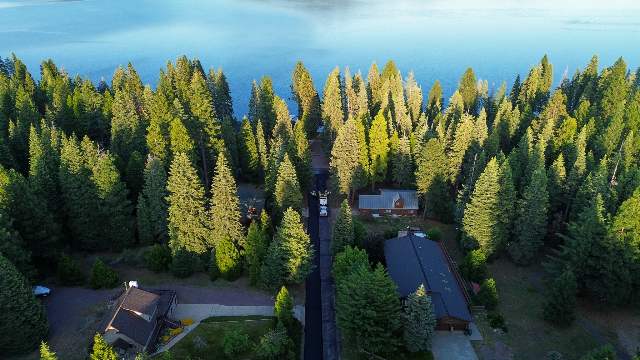 Aerial view of paving project amid alpine forest