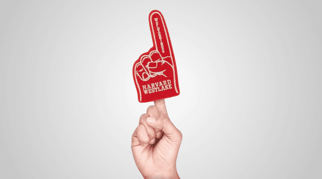 A mini red foam finger worn on the index finger of a hand.