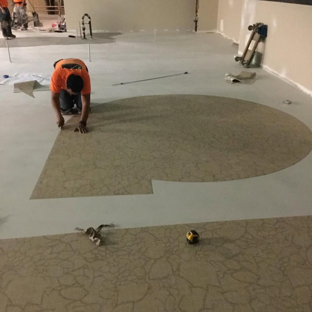 Installer setting a curved vinyl inlay into the cut-out