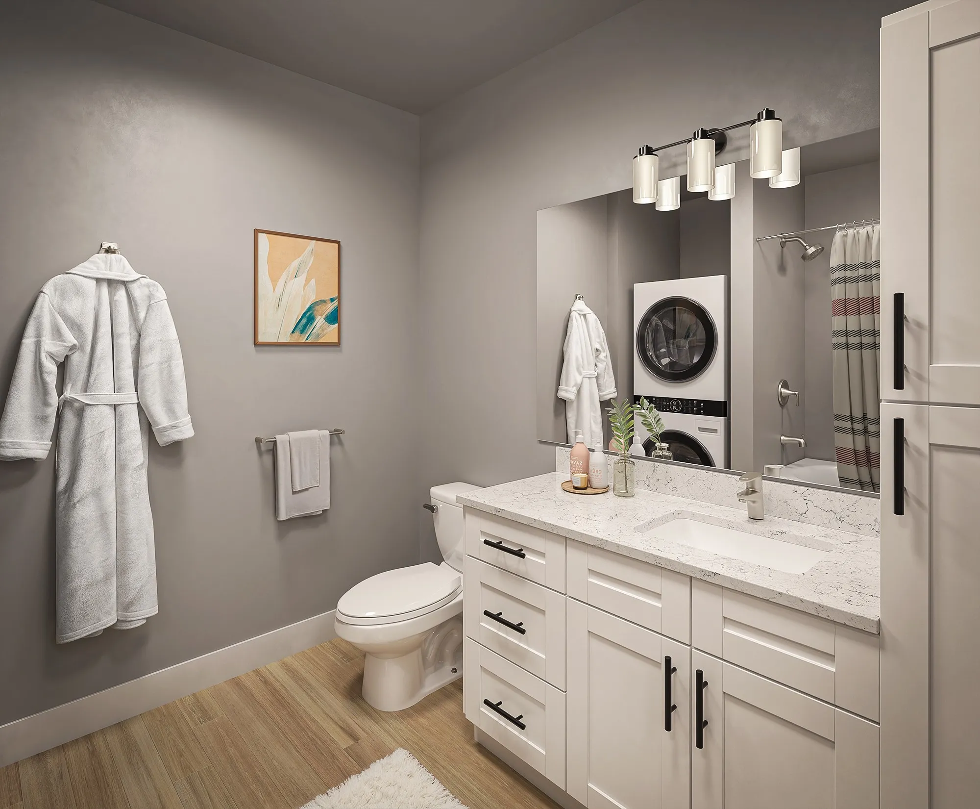 A bathroom featuring a stacked washer and dryer, with neutral-colored walls and tiled flooring.
