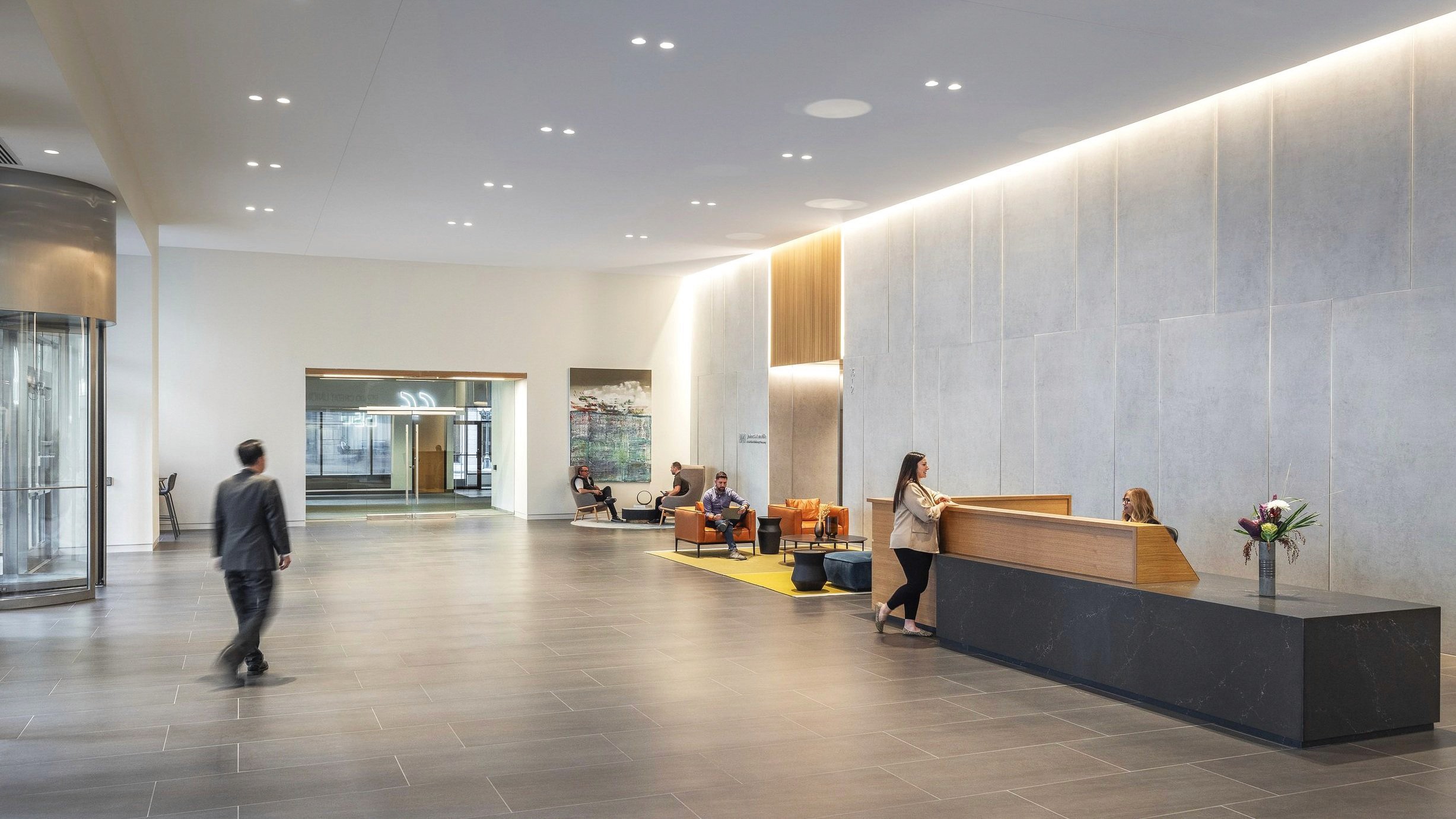 Modern lobby with reception, seating, and artwork.
