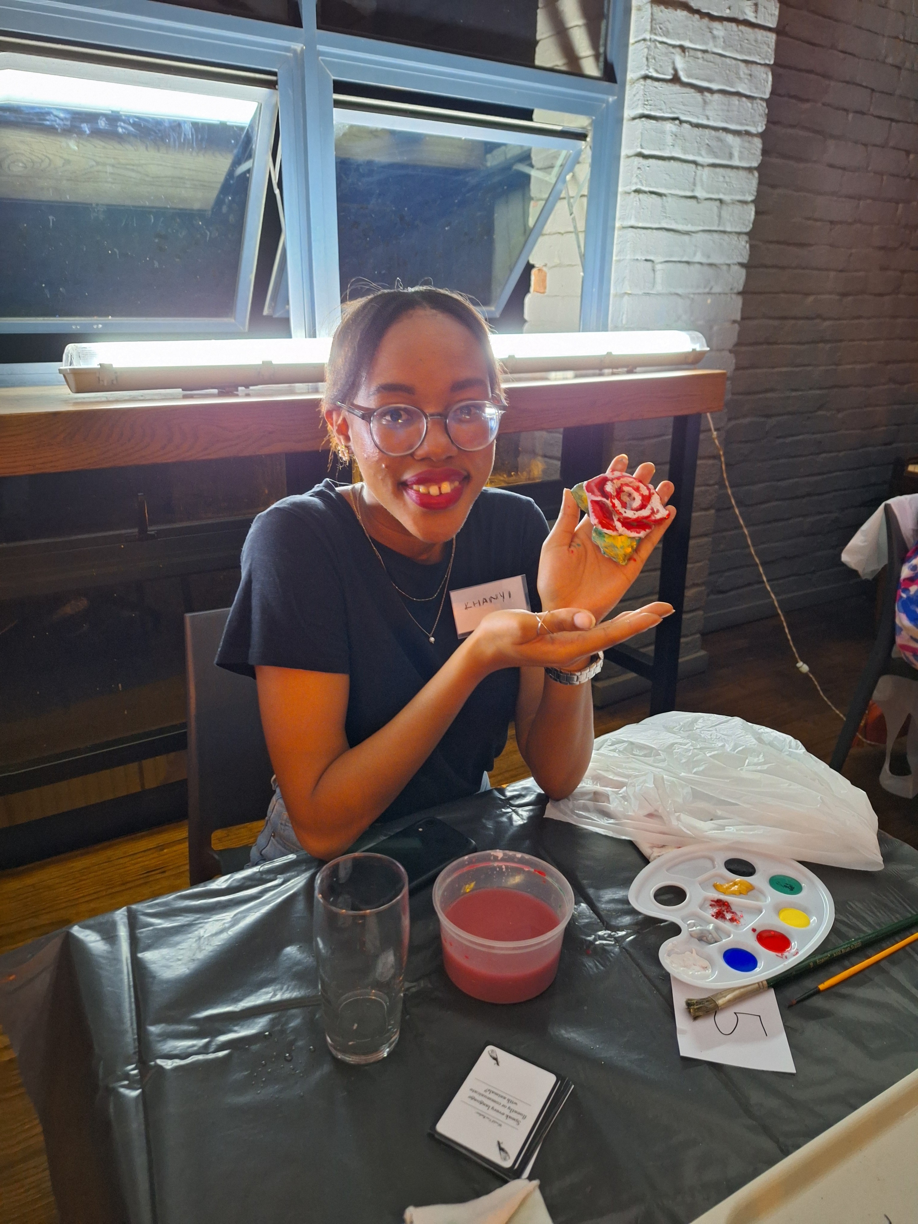 A girl smiling for a photo wearing glasses