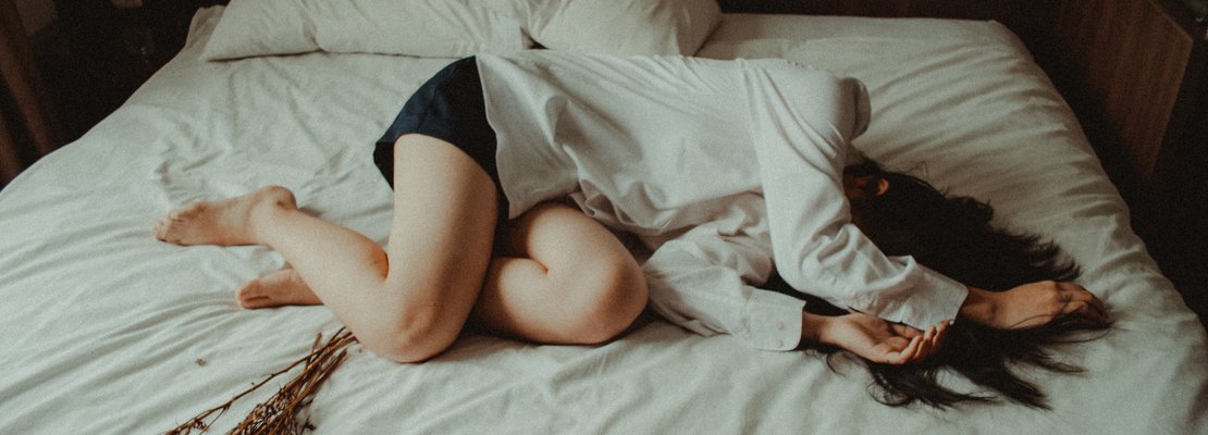a woman lying on bed
