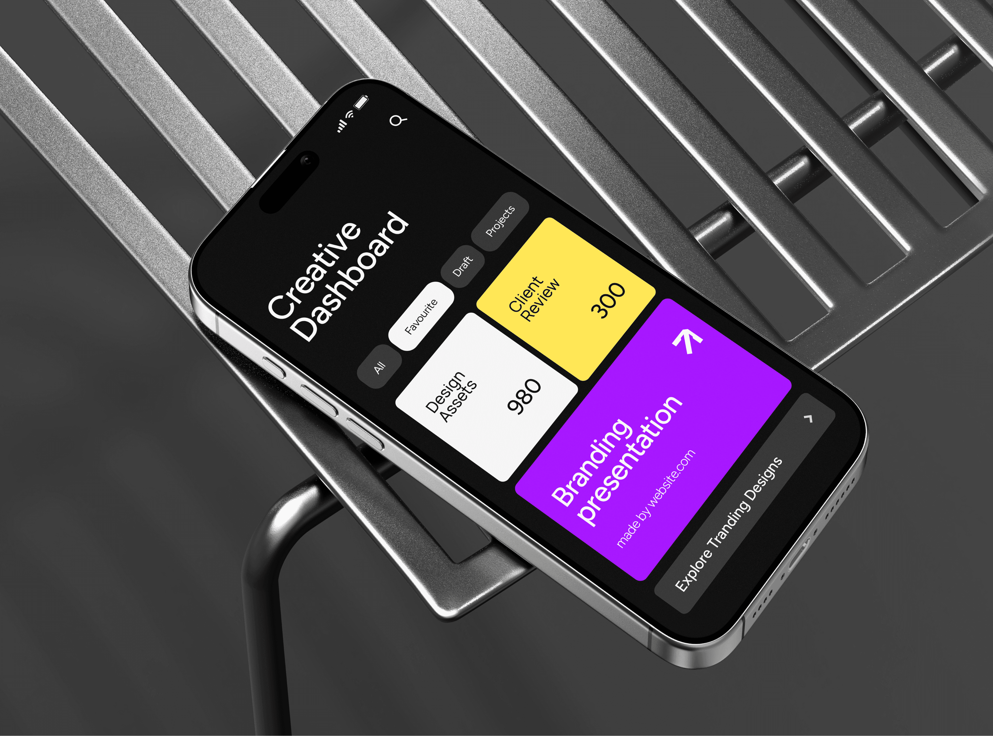 High-angle close-up of an iPhone mockup resting on a brushed metal slatted surface, showcasing a professional mobile app dashboard with bold typography and colorful design assets.