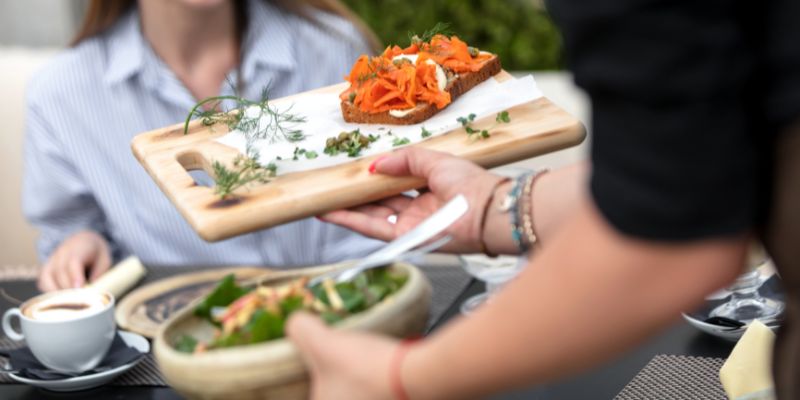 An F&B staff serving a customer