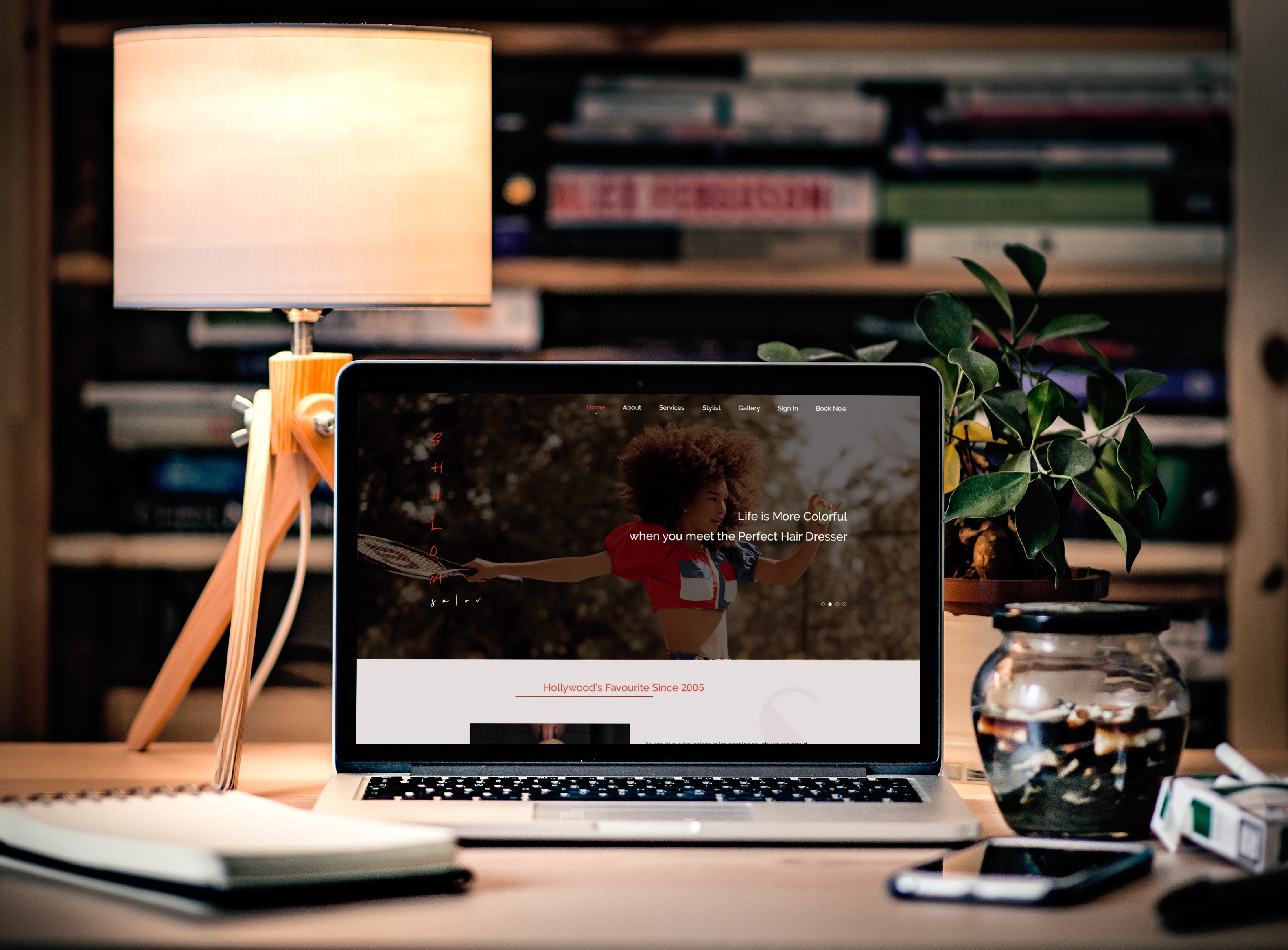 A mockup of a Macbook with the header of the website