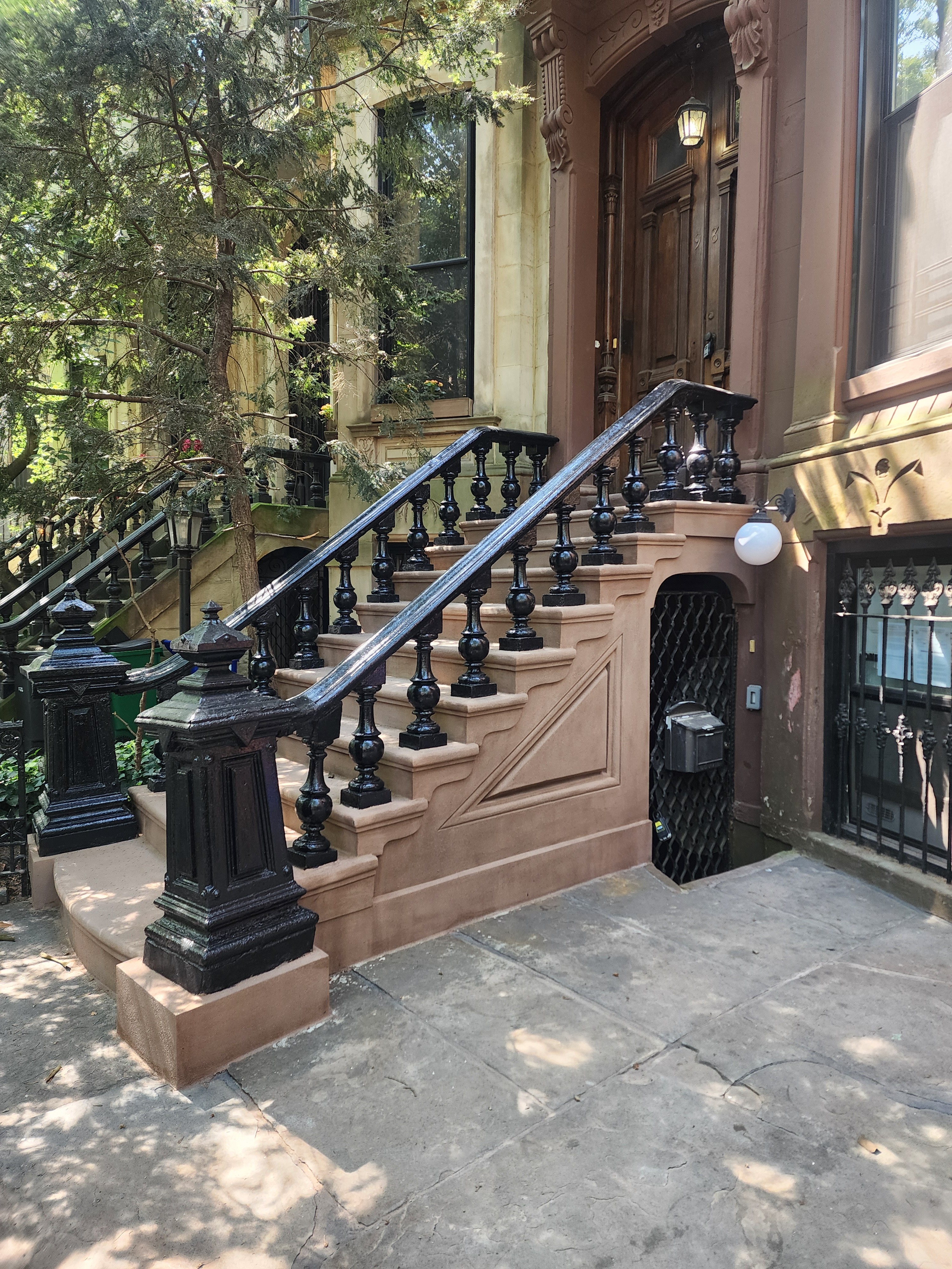 Restored historic brownstone stoop featuring detailed sandstone masonry repair in Park Slope, Brooklyn, NYC