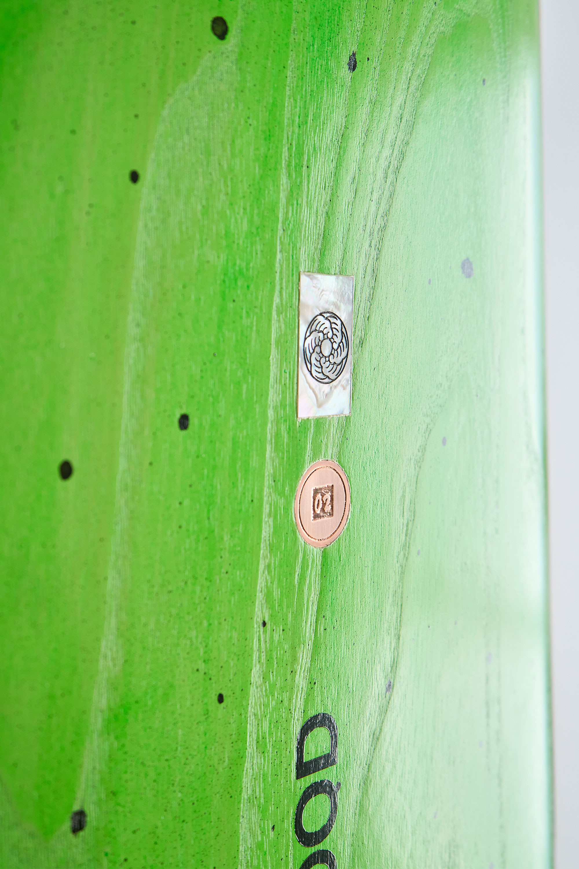 Mother of pearl and copper inlays on a timber surfboard