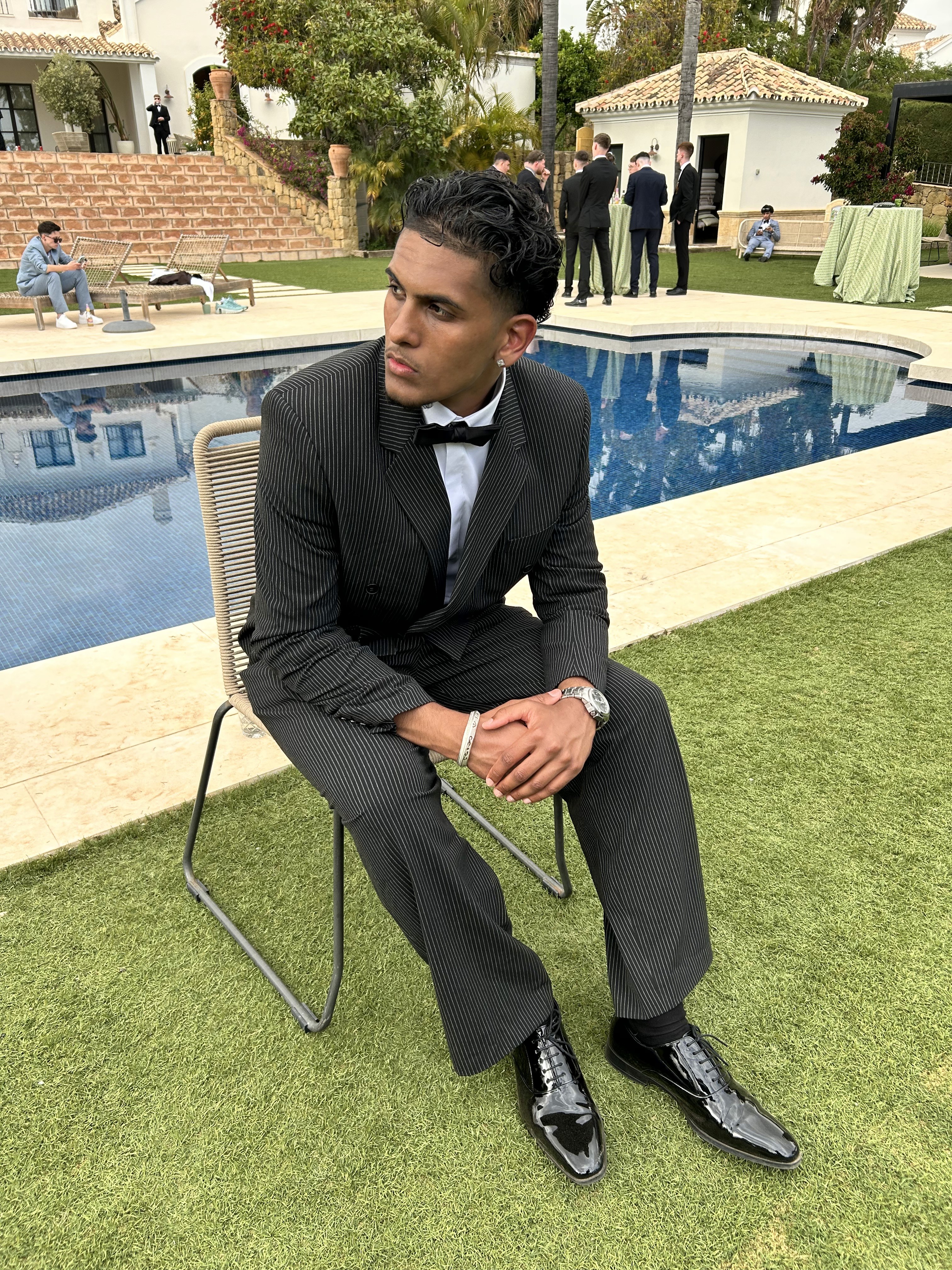 Gurjevan Singh in a suit at an outdoor event