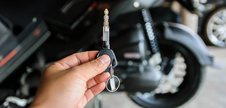 person holding motorcycle key