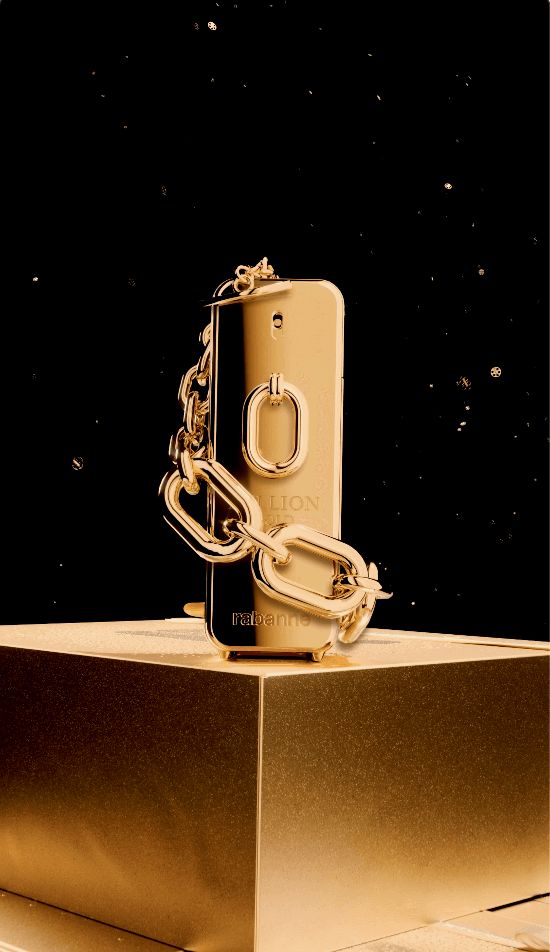 A metallic gold Rabanne bottle, draped in a thick gold chain, sits on a pedestal against a dark and sparkling backdrop.