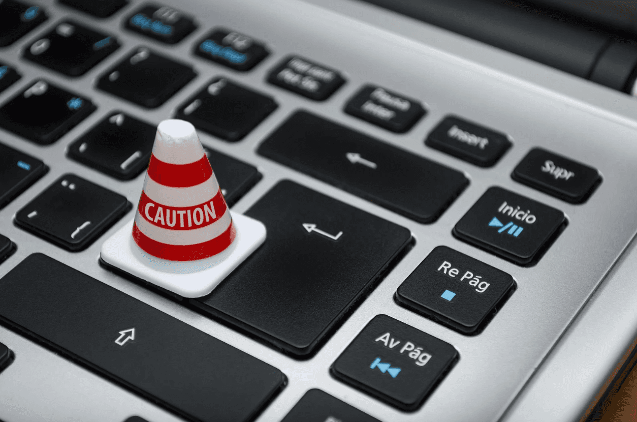 Mini caution cone on a keyboard — highlighting the importance of maintaining control and awareness even with automated Amazon Ads systems.