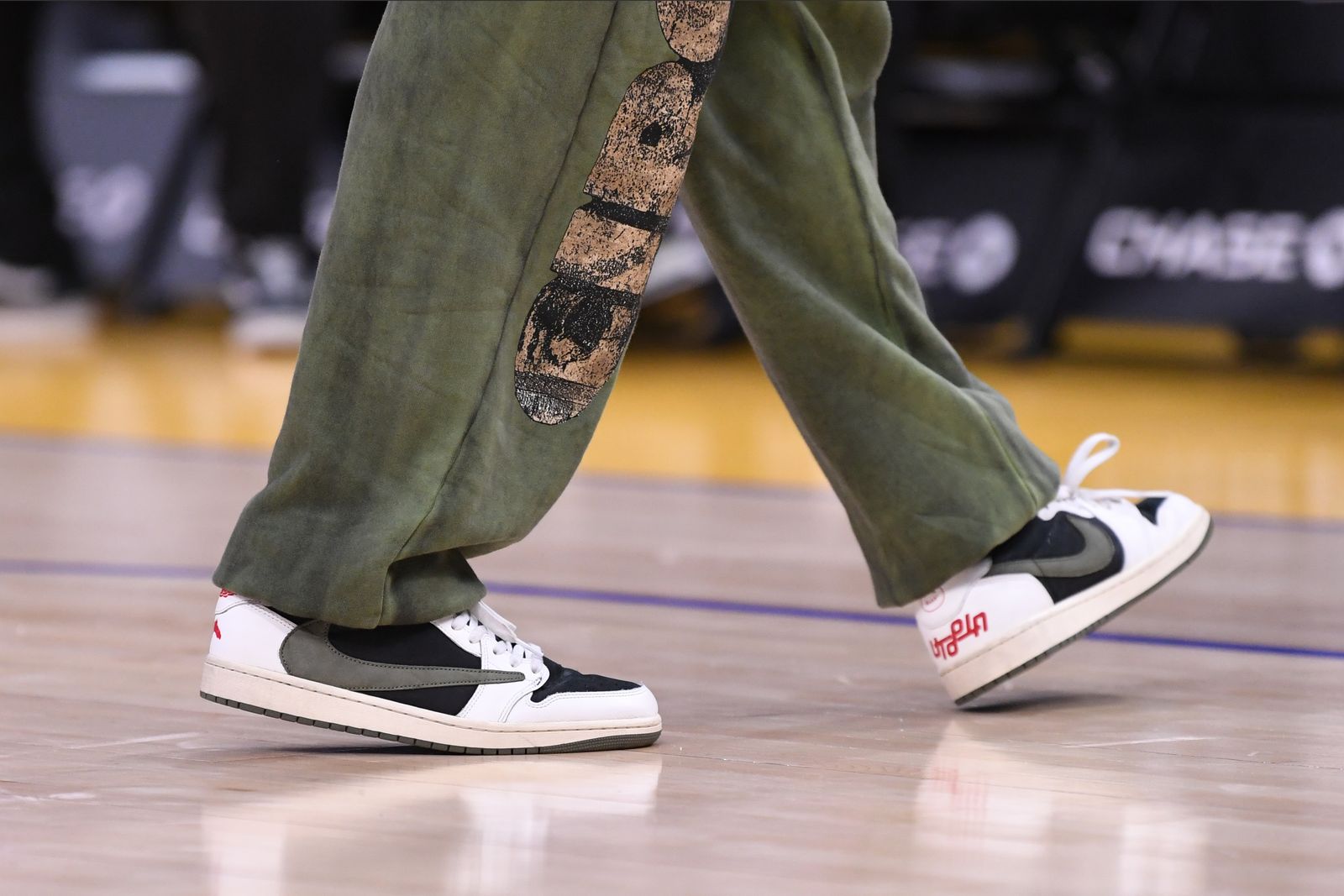 a pair of sneakers sitting on top of a lush green field