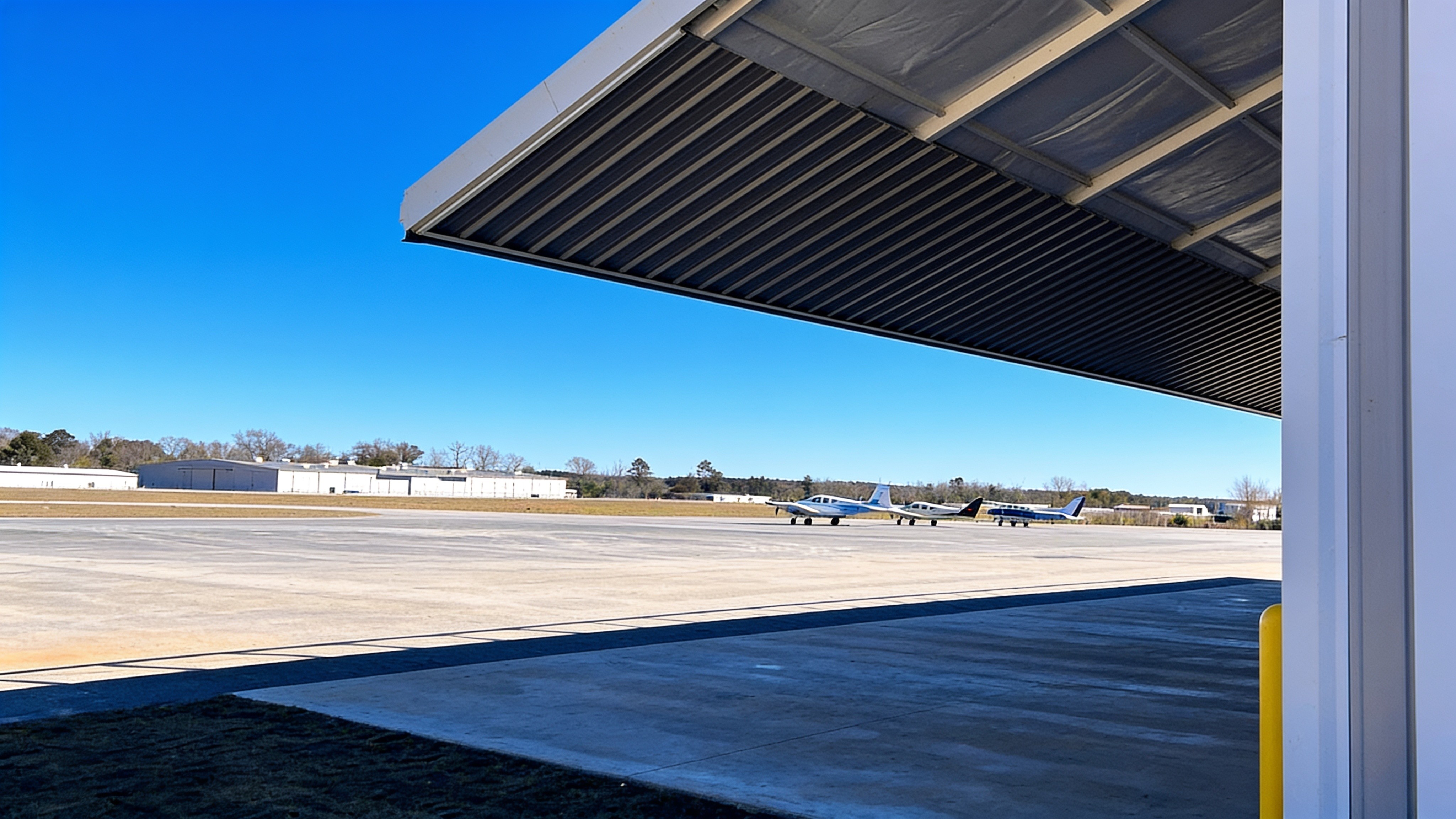 Wide metal hangar with a raised PowerLift hydraulic door