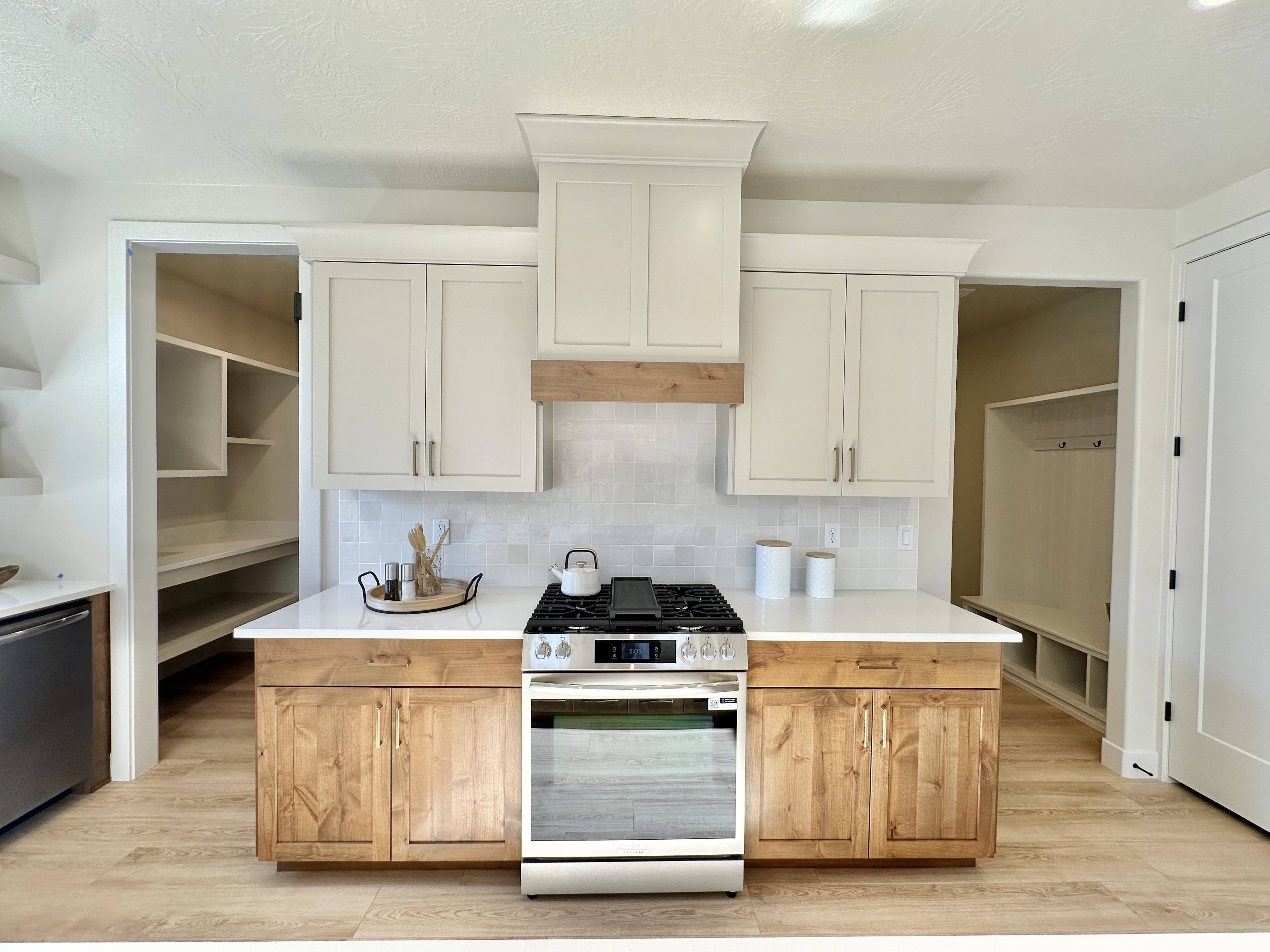 Kitchen at The View at Falcon Ridge, Hurricane, Utah, highlighting white cabinets, wood accents, and a functional island for meal prep and gathering.
