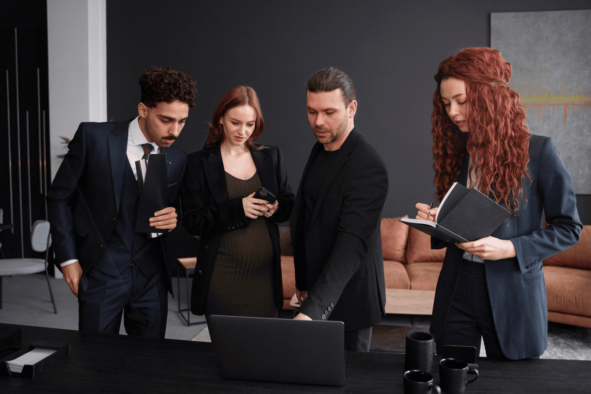 Man in suit interviews woman holding clipboard.