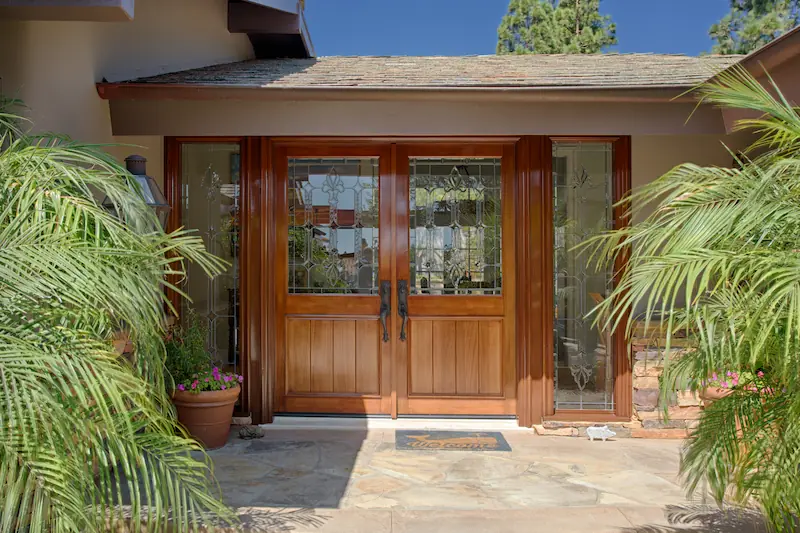 Beautiful stained wood front entry doors with sidelites. From the Big Canyon Remodel project. Photo by Chris Darnall.