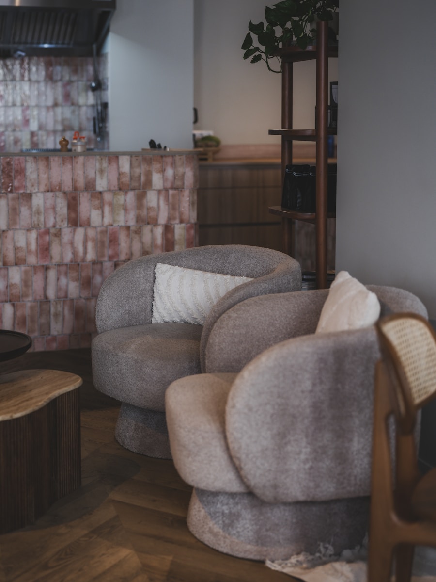Bouclé Armchair — Two plush armchairs with pillows in a cozy room.
