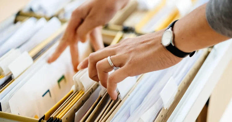 Stack of paperwork and a filing cabinet symbolizing Documentation & Filing with Fibi Law