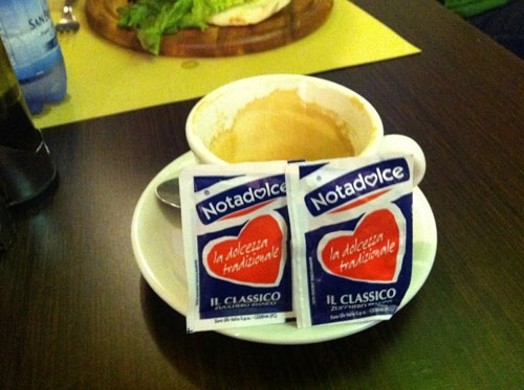 Empty cup of coffee with Notadolce sachets