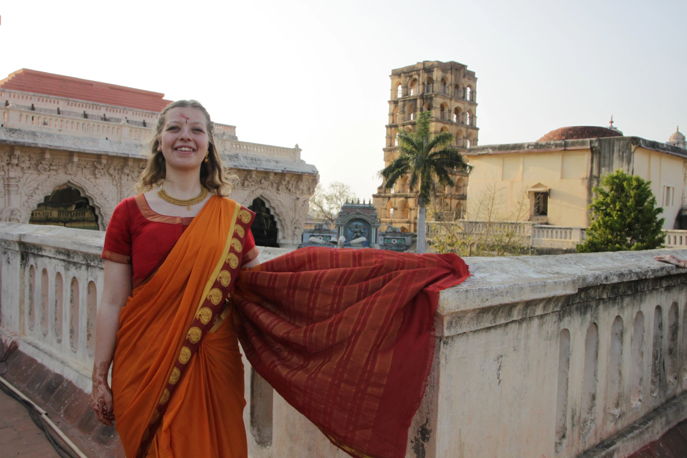 Woman smiling at the camera, dressed in traditional Indian clothes (sari)