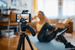 A content creator filming a video on a smartphone mounted on a tripod