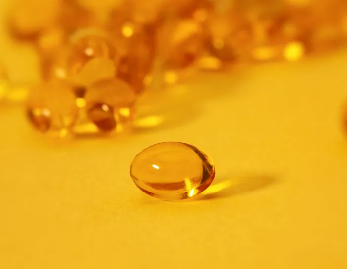 An orange algae or fish oil pill
