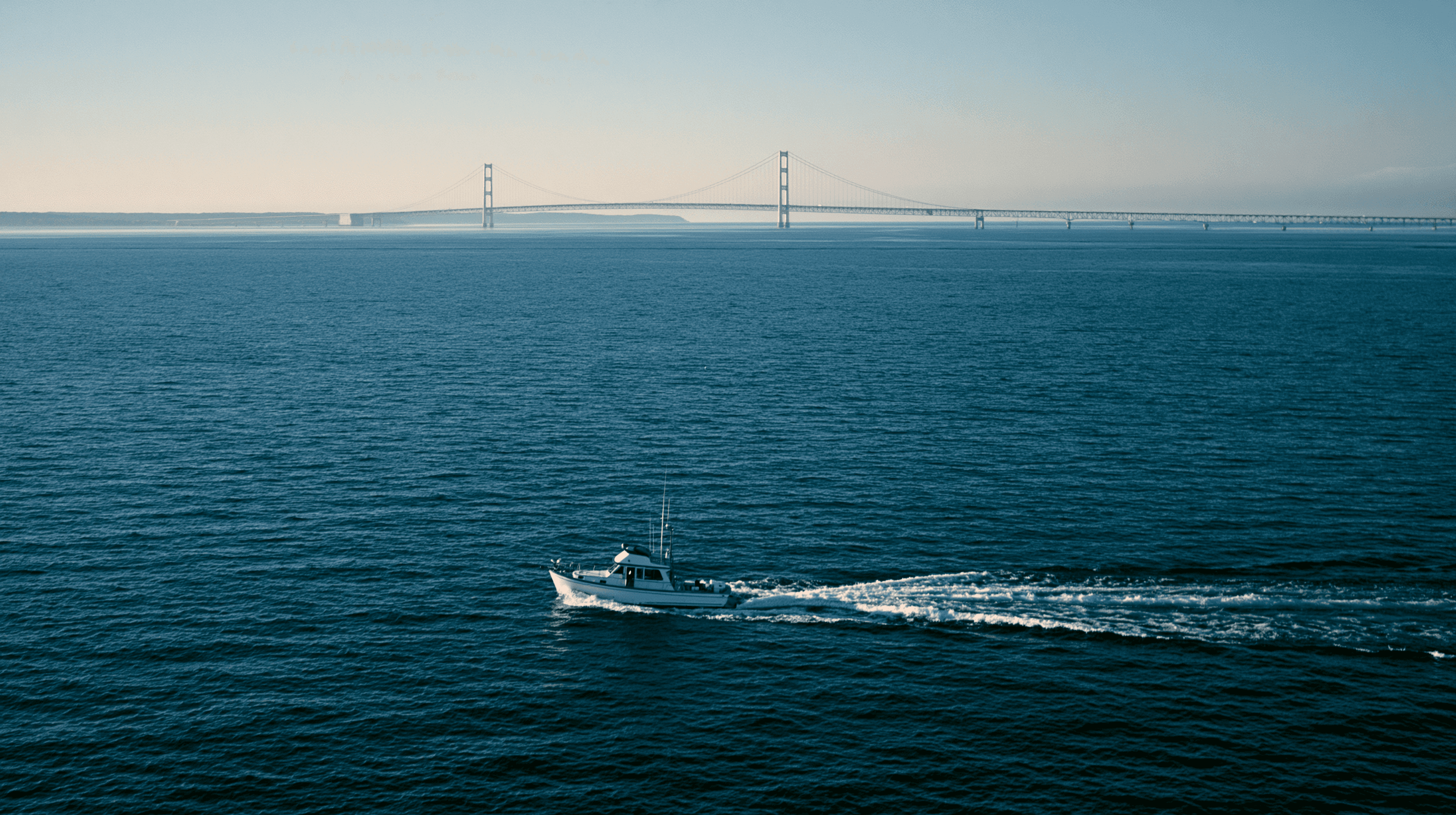 Wide view across the Straits of Mackinac with the suspension bridge in the middle