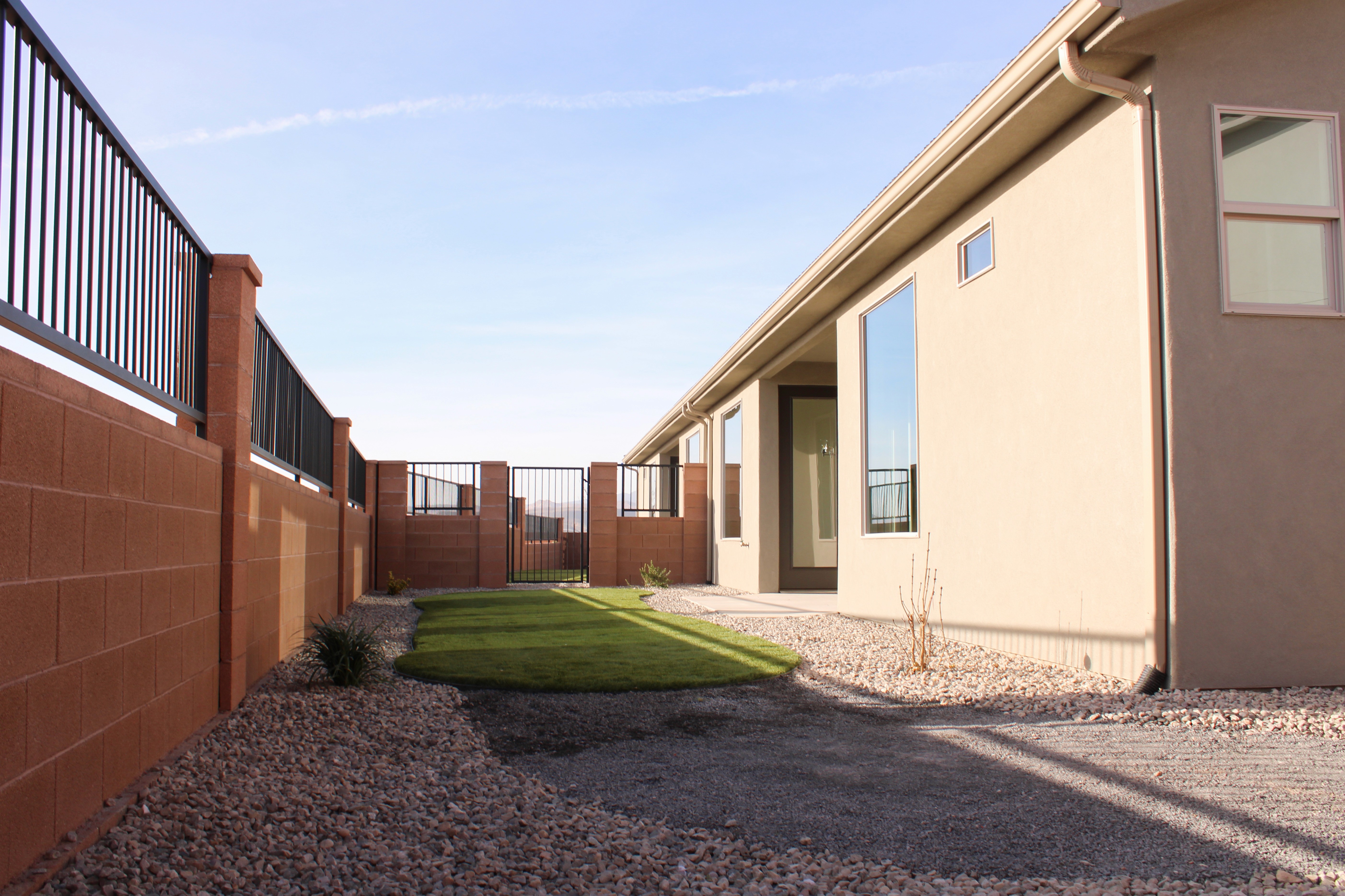 Backyard view of the Golden Hour home in Hurricane, Utah with patio space and outdoor living area.