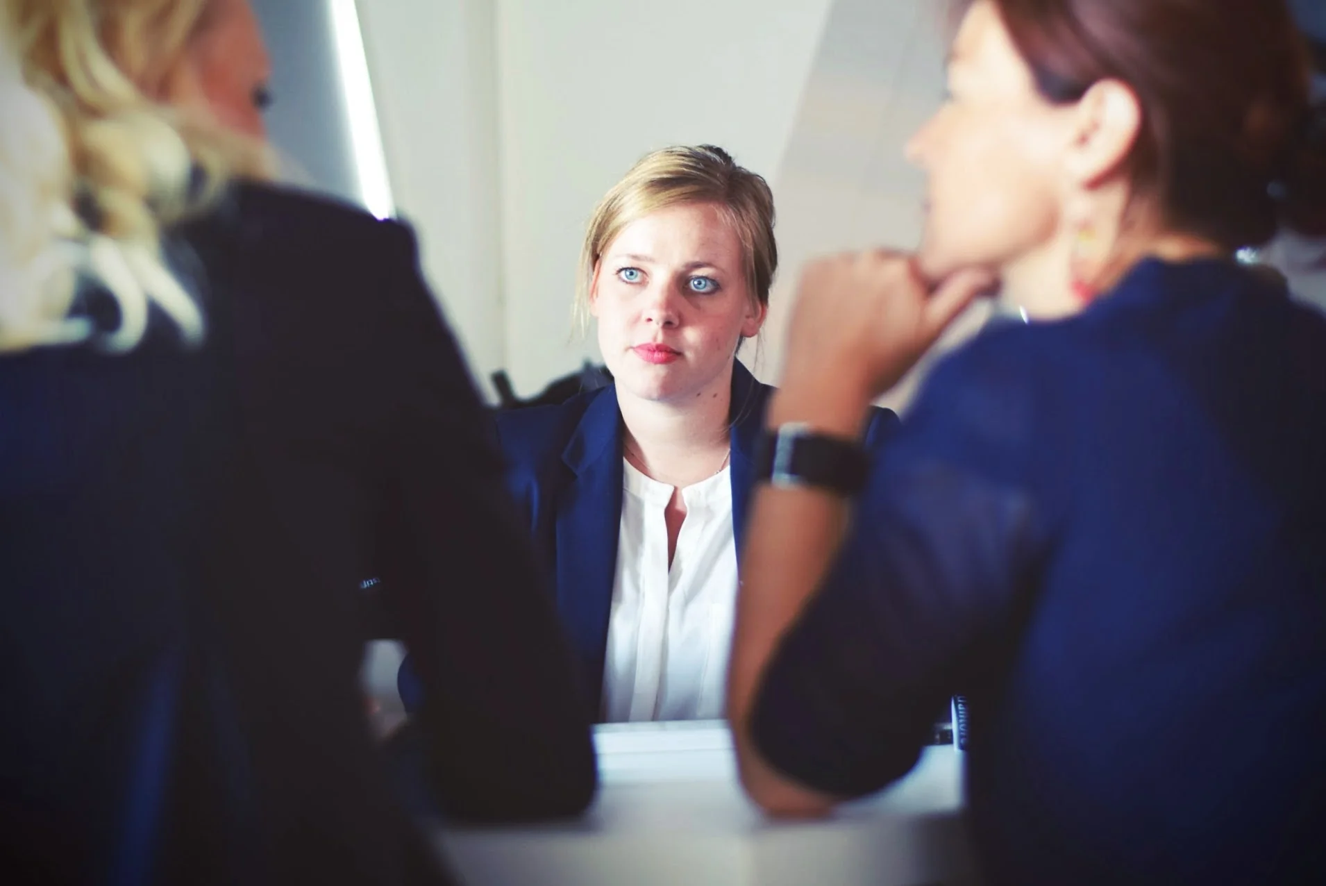 Professional shaking hands with client in modern meeting room