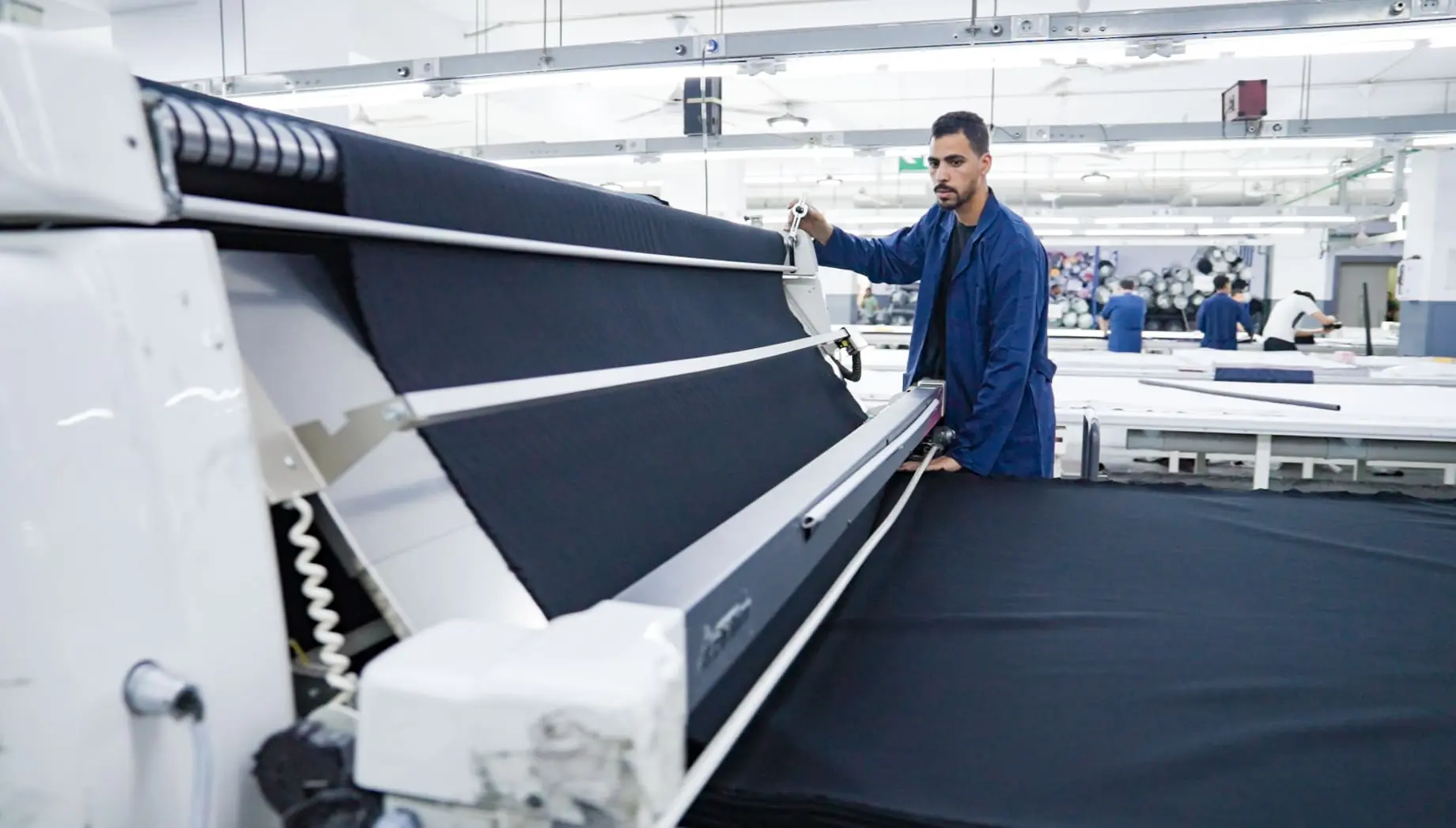 Worker uses spreading machine.