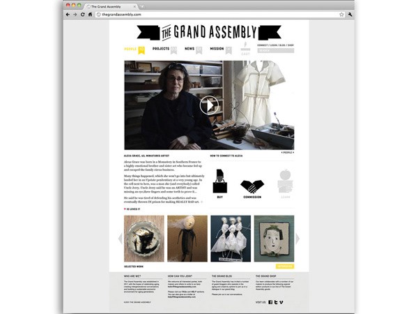 A screenshot of the Grand Assembly website displays a clean, minimalist design with a white background. The navigation bar includes links for "People," "Projects," "News," "Mission," "Connect," "Login," and "Shop." A central image shows a person in a dark jacket seated at a desk, with a white dress displayed nearby. A video player is visible in the upper right corner. Below the image are several smaller images showcasing clothing and accessories. Text elements include “How to Connect to AEA,” “Select Work,” and “Select a Blog.” A search bar is at the top, and a “Visit Us” link is at the bottom.