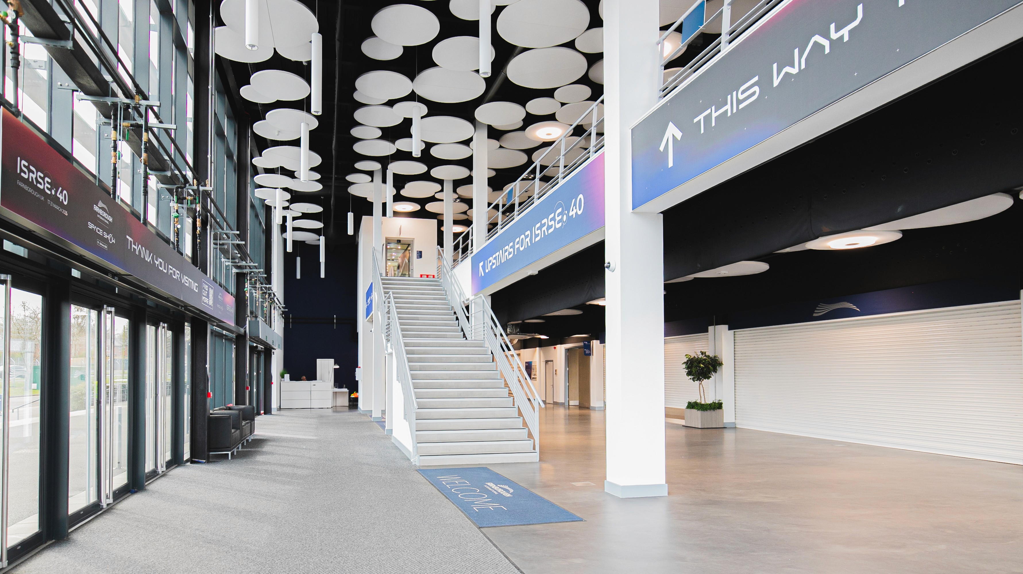 Two classic volkswagen beetles, one green, one cream.