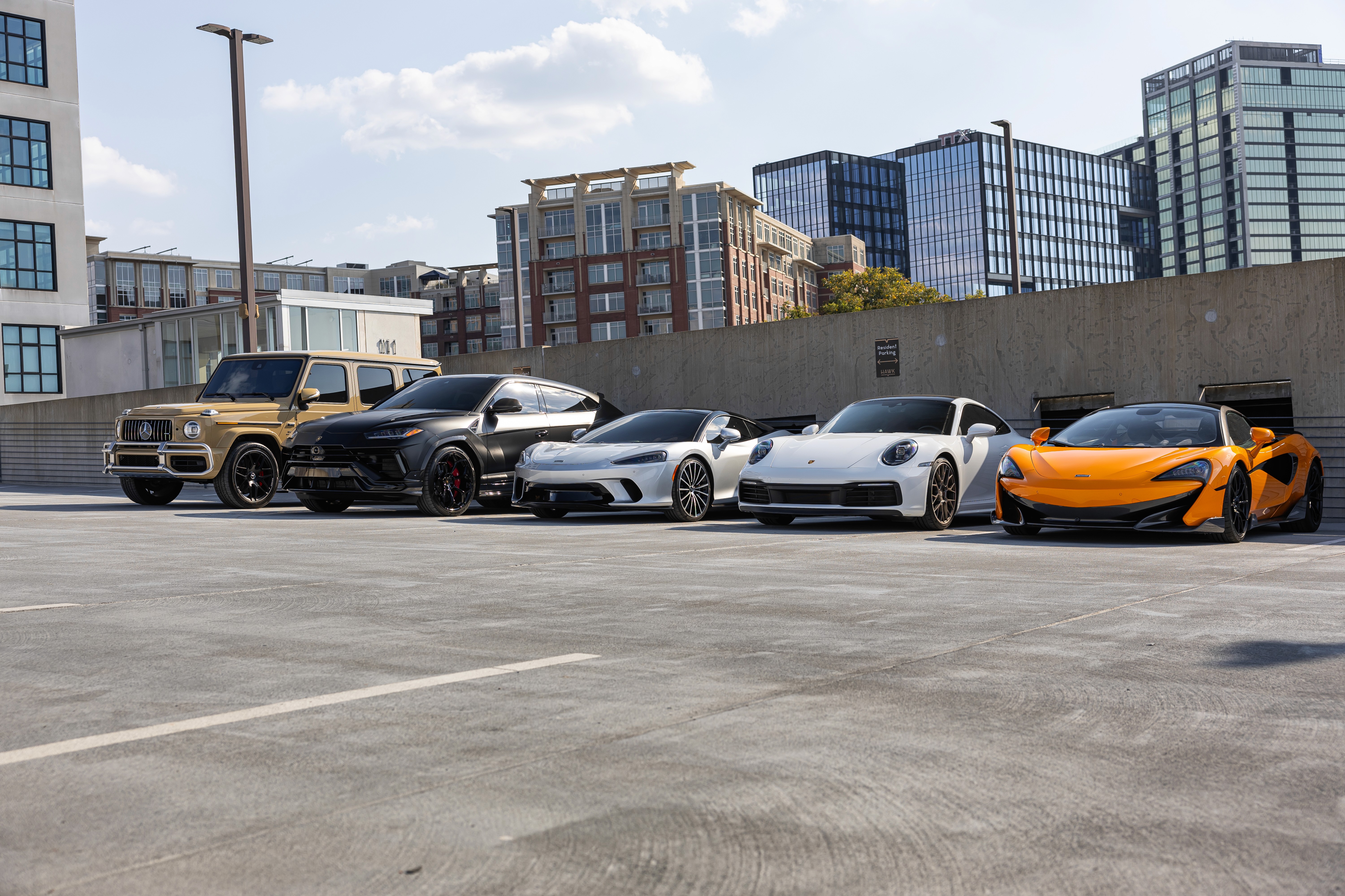 Collection of luxury sports cars displayed in modern rental showroom