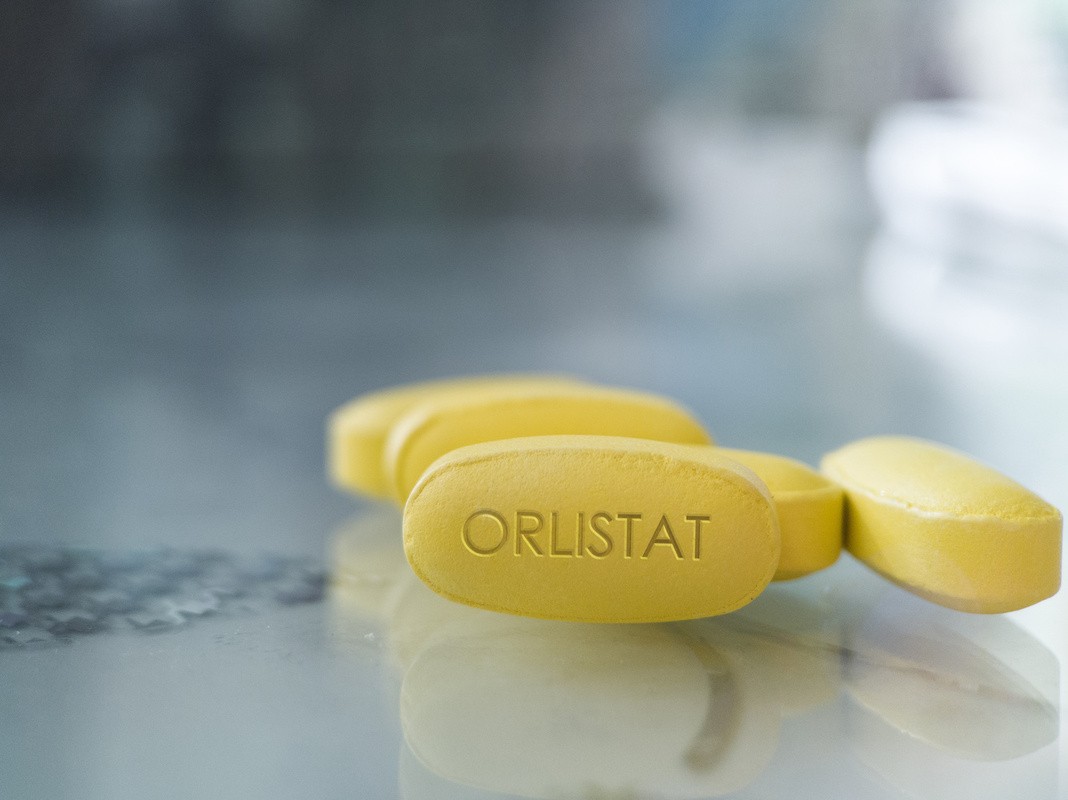 orlistat pills on a table, showing a good option for the best weight loss pill
