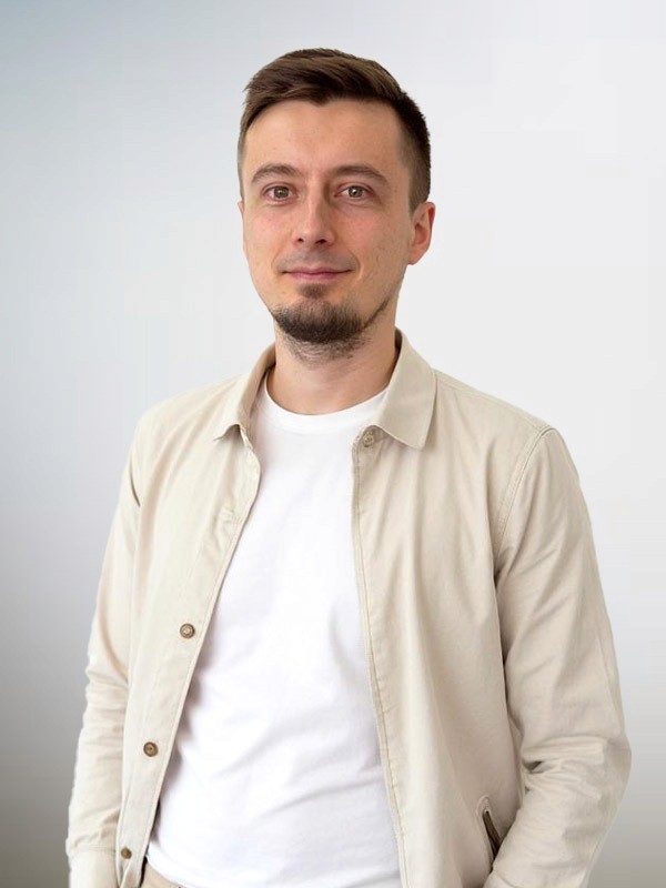 woman in white and black stripe shirt sitting on brown rock