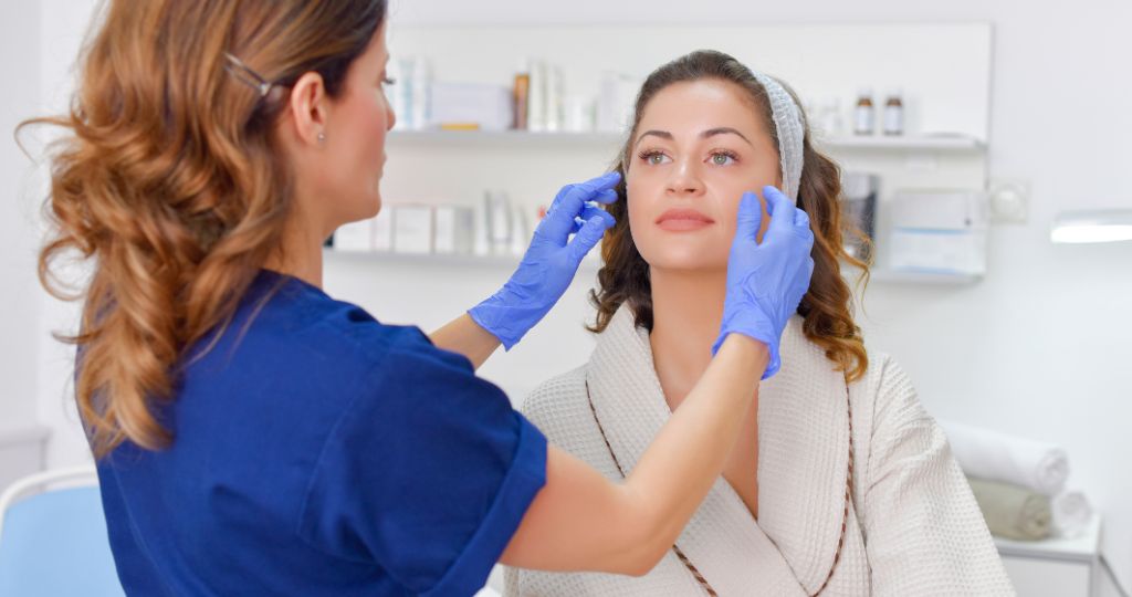 Cosmetic surgeon examining a patient in a clinic.