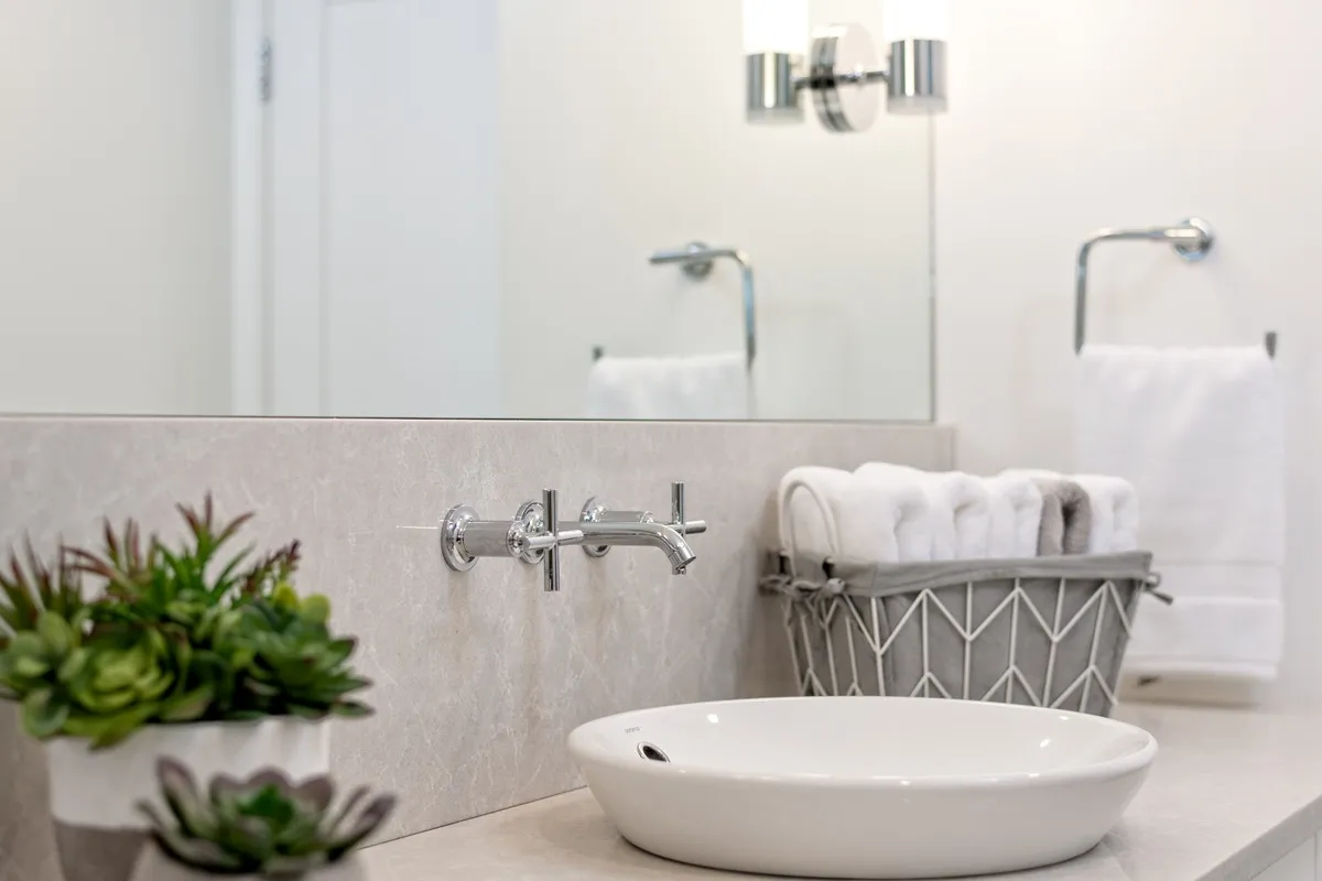 Image of KHD Homes bathroom design with sink, mirror, and modern fixture in a luxurious primary ensuite.