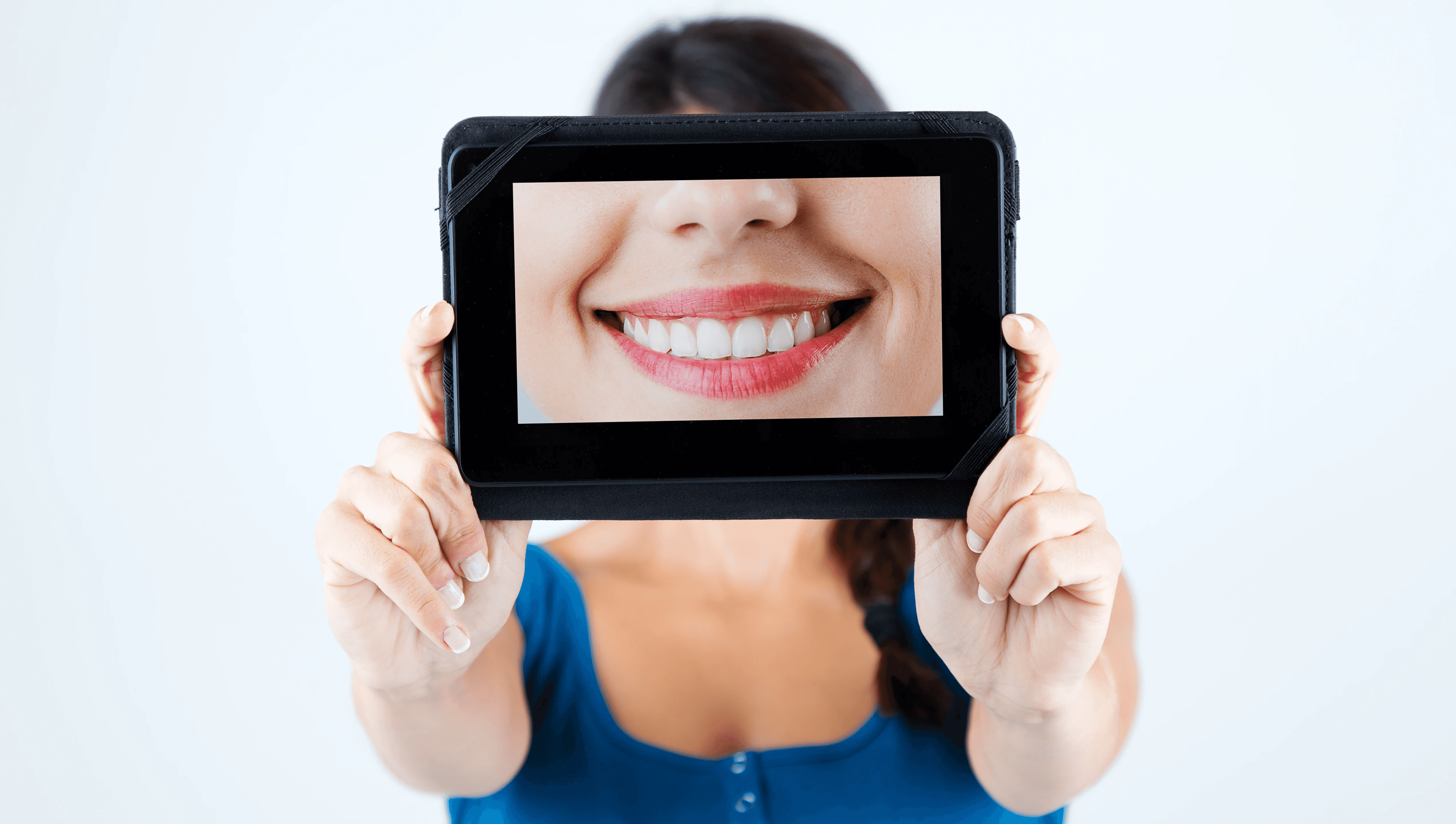 A woman showcasing her beautiful smile after receiving orthodontics treatment from Invisalign Center