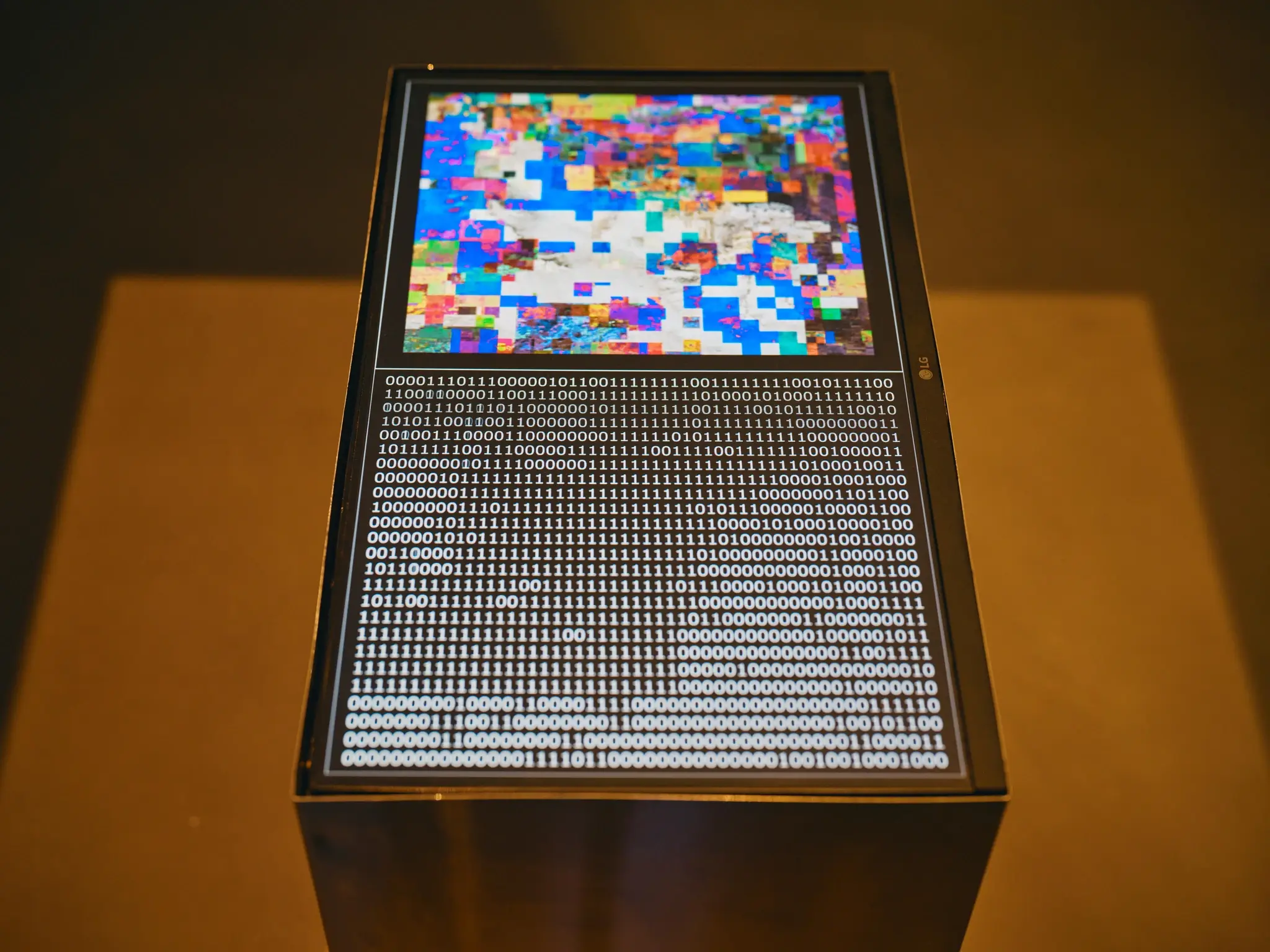 Pixelated image and binary code on a screen.