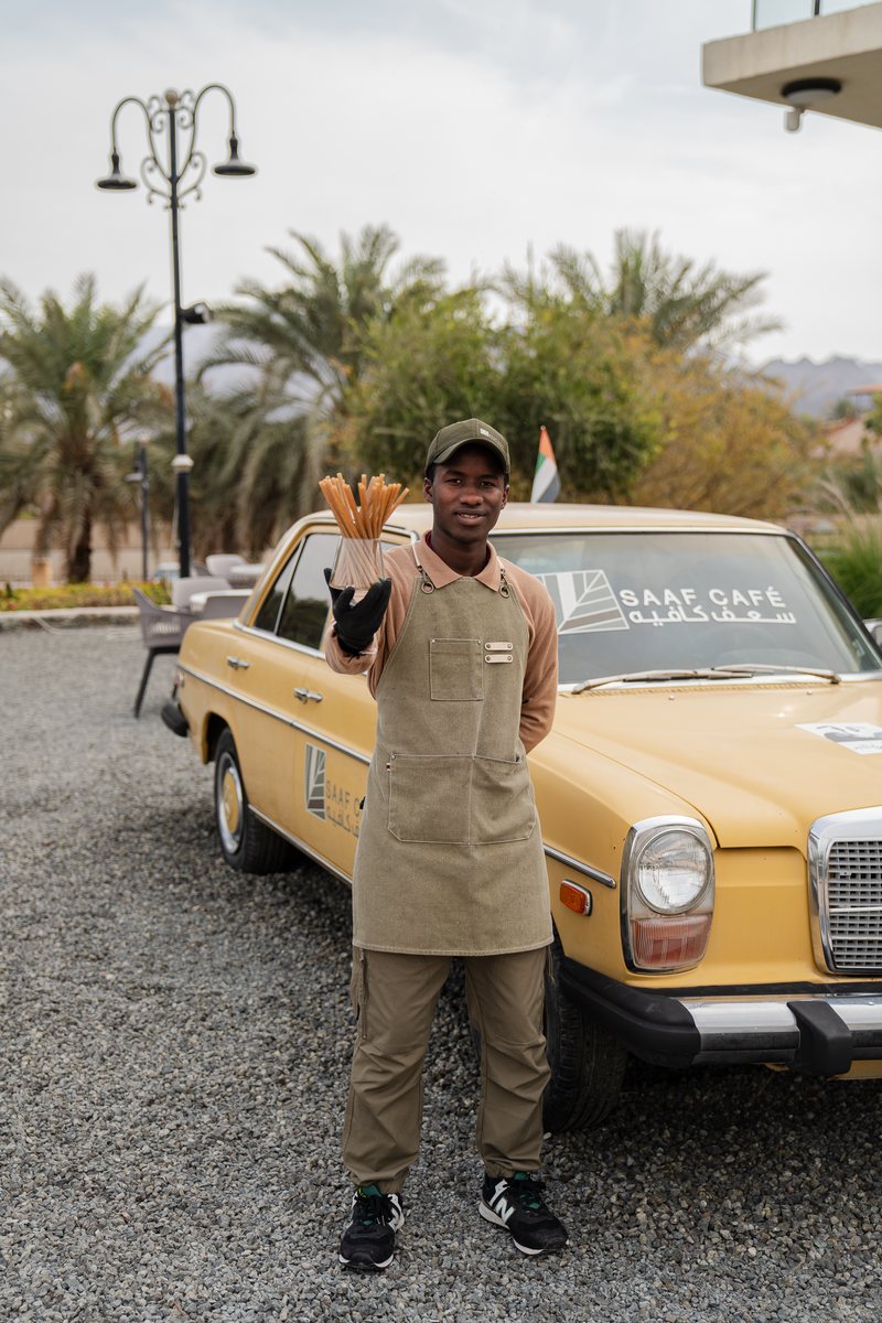A Saaf Cafe barista holding Palmade straws