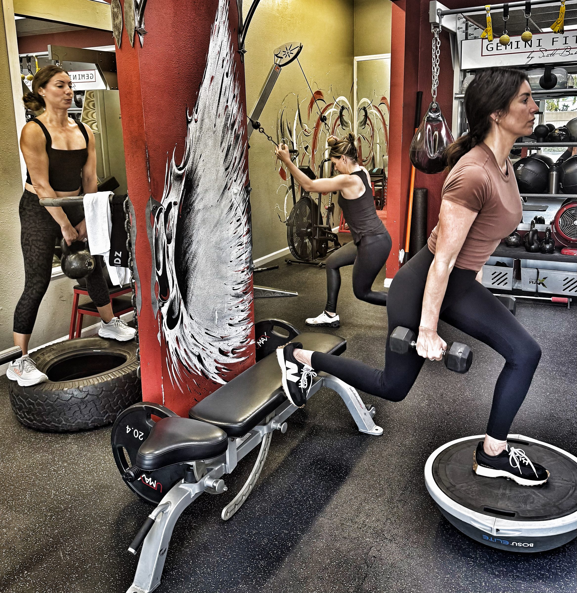 Three clients doing lunges and cable exercises in a small group personal training session at Gemini Fit, Solana Beach