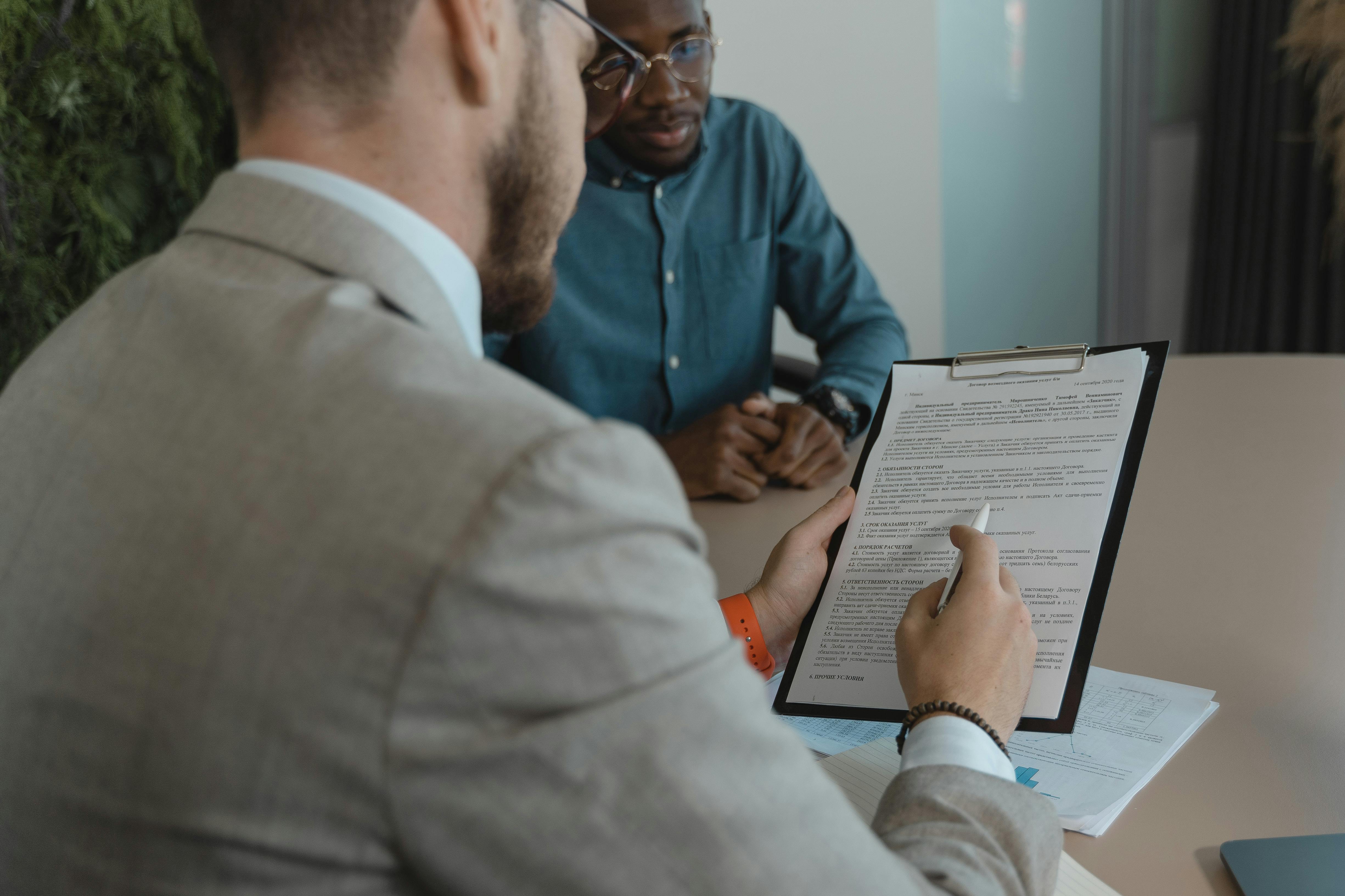 A compliance manager conducting an internal compliance document with a member of the organization