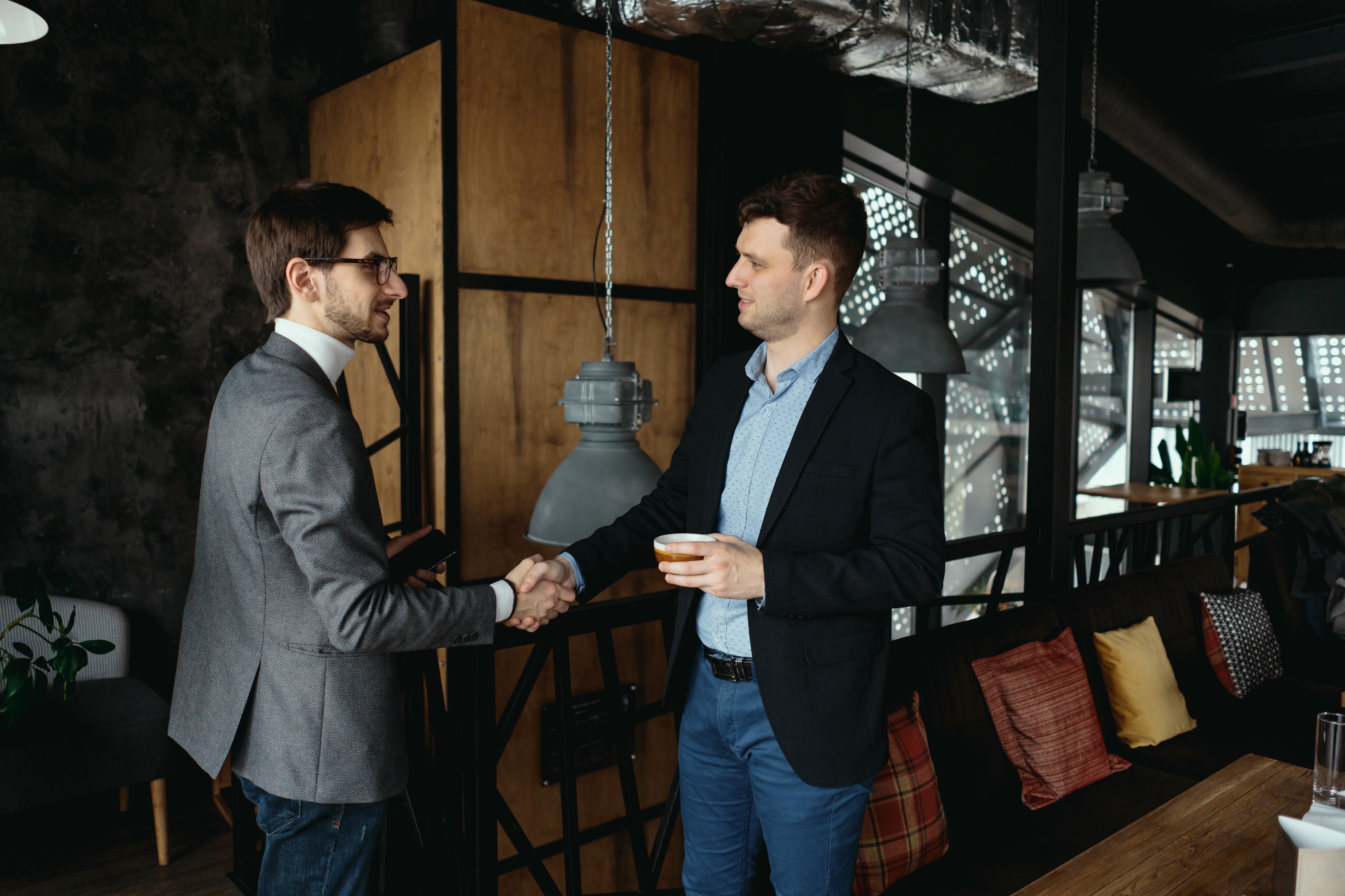 two-young-businessmen-greeting-each-other-shaking-hand