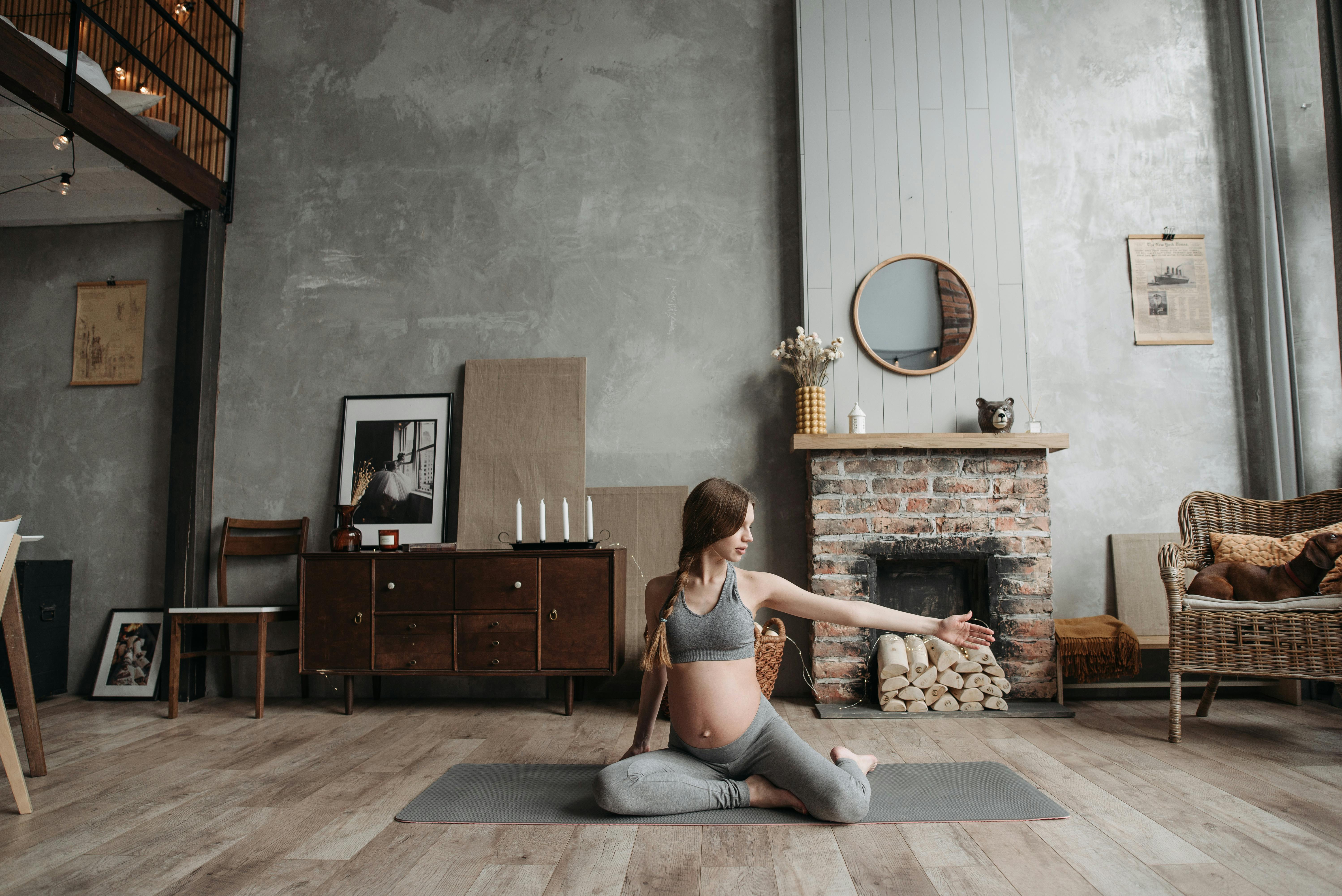 A pregnant woman practicing mat pilates.