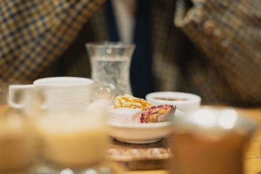 A table set with Turkish coffee, a small dessert, and water, with the focus on the elegant presentation and the rich cultural experience of enjoying coffee in Istanbul.